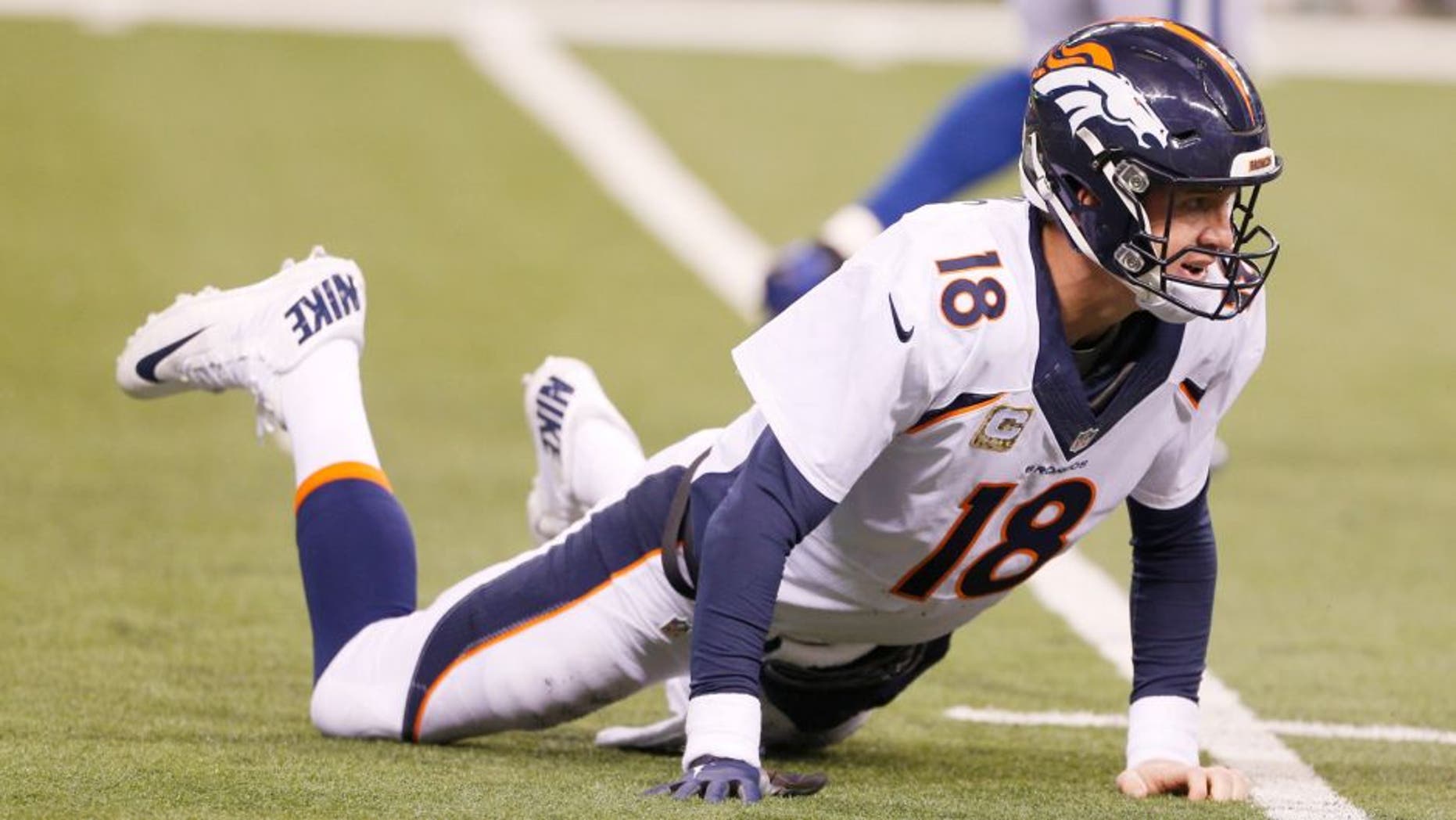 Nov 8, 2015; Indianapolis, IN, USA; Denver Broncos quarterback Peyton Manning (18) looks up while on the ground after throwing an interception against the Indianapolis Colts at Lucas Oil Stadium. Indianapolis defeats Denver 27-24. Mandatory Credit: Brian Spurlock-USA TODAY Sports