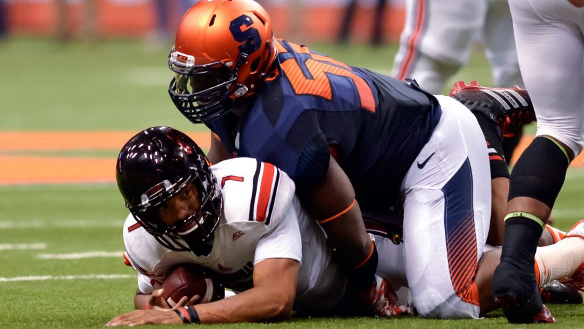 Oct 3, 2014; Syracuse, NY, USA; Louisville Cardinals quarterback Reggie Bonnafon (7) is sacked by Syracuse Orange nose tackle Eric Crume (52) during the second quarter of a game at the Carrier Dome. Mandatory Credit: Mark Konezny-USA TODAY Sports