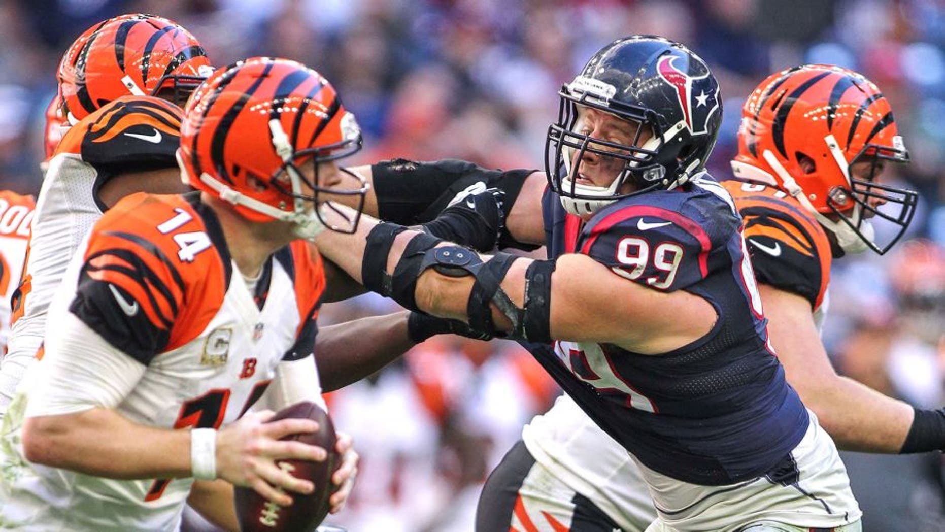Nov 23, 2014; Houston, TX, USA; Houston Texans defensive end J.J. Watt (99) applies pressure to Cincinnati Bengals quarterback Andy Dalton (14) during the game at NRG Stadium. Mandatory Credit: Troy Taormina-USA TODAY Sports