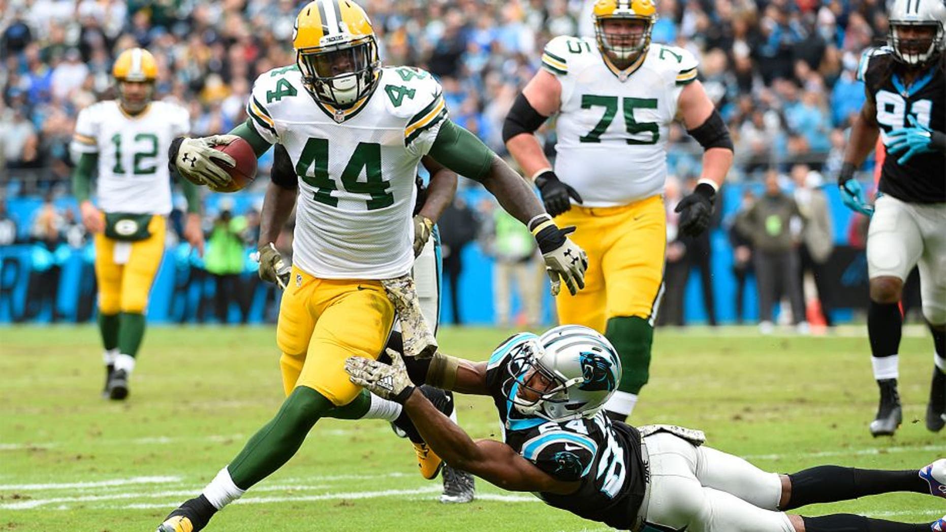 Nov 8, 2015; Charlotte, NC, USA; Green Bay Packers running back James Starks (44) runs as Carolina Panthers cornerback Josh Norman (24) defends in the first quarter at Bank of America Stadium. Mandatory Credit: Bob Donnan-USA TODAY Sports