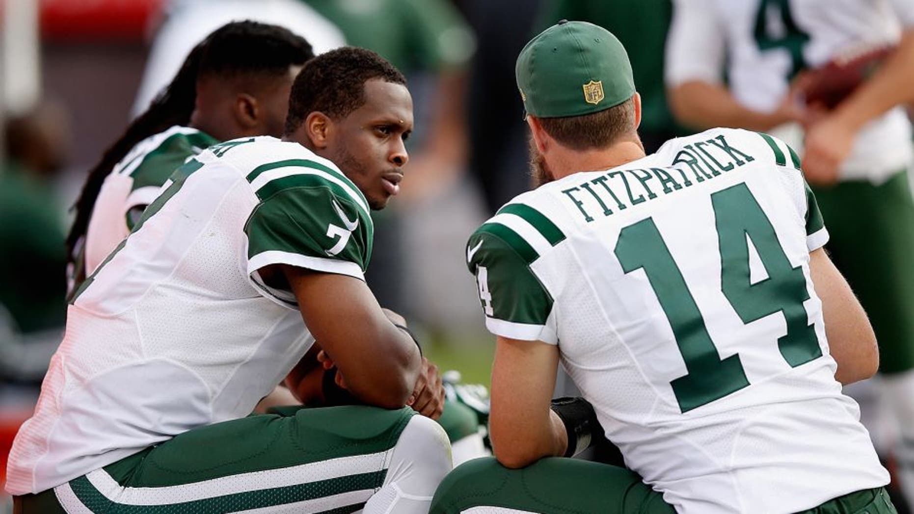 OAKLAND, CA - NOVEMBER 01: Geno Smith #7 of the New York Jets talks to Ryan Fitzpatrick #14 on the sidelines during their game against the Oakland Raiders at O.co Coliseum on November 1, 2015 in Oakland, California. (Photo by Ezra Shaw/Getty Images)
