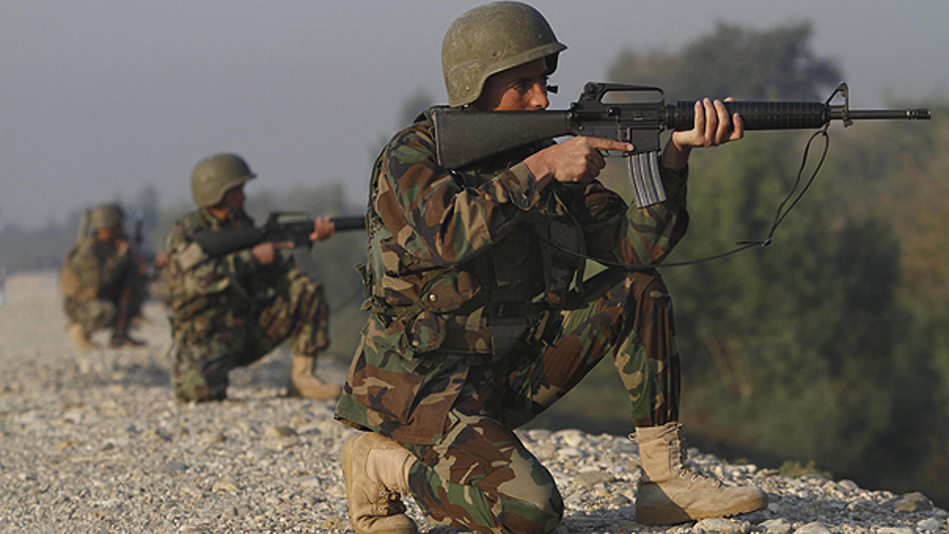 Nov. 13: Afghan National Army soldiers take positions at the site of a gunbattle near the Jalalabad military air base in Jalalabad, east of Kabul, Afghanistan.