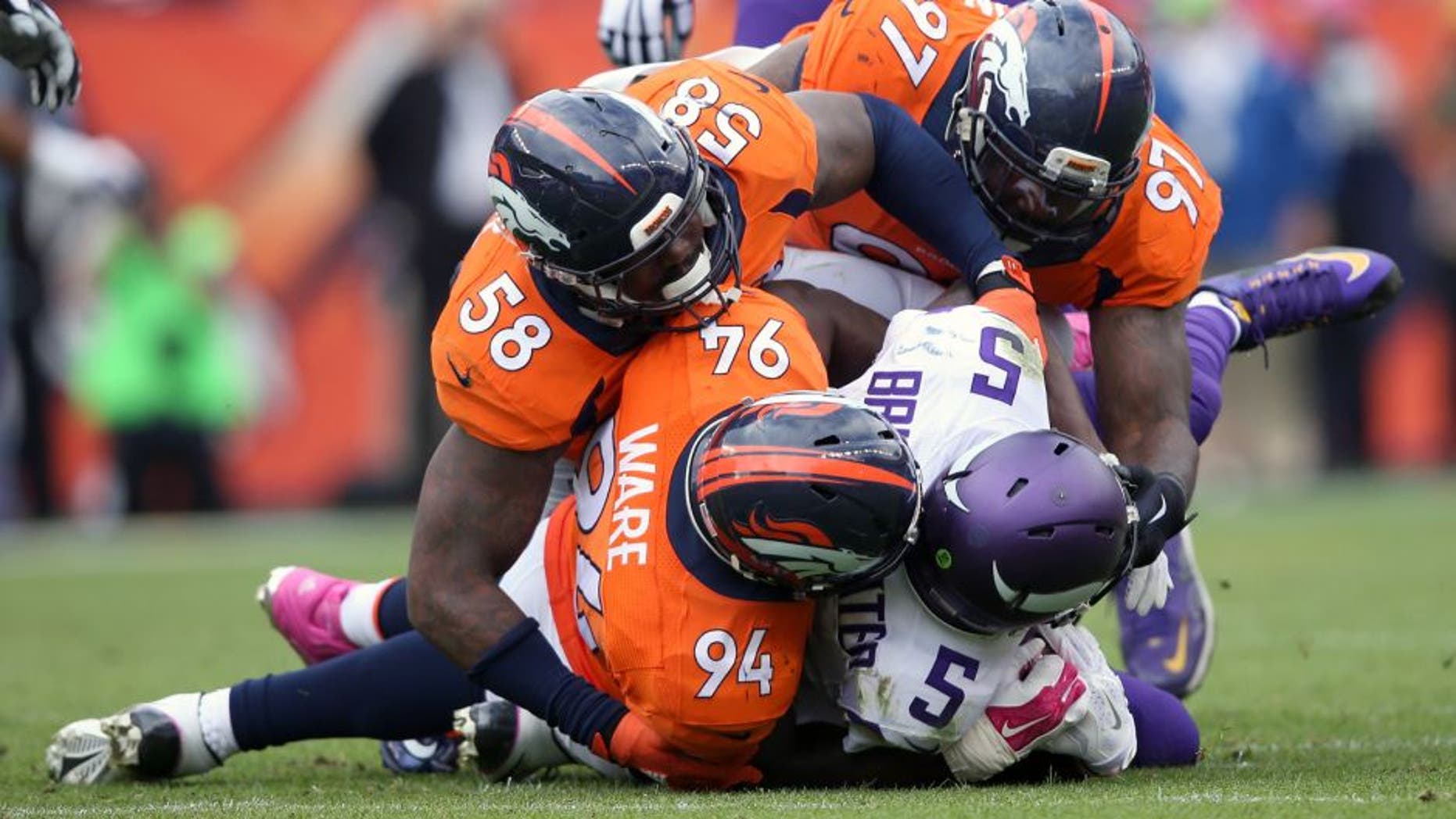 DENVER, CO - OCTOBER 04: Outside linebacker Von Miller #58, outside linebacker DeMarcus Ware #94 and defensive end Malik Jackson #97 of the Denver Broncos gang tackle quarterback Teddy Bridgewater #5 of the Minnesota Vikings at Sports Authority Field at Mile High on October 4, 2015 in Denver, Colorado. The Broncos defeated the Vikings 23-20. (Photo by Doug Pensinger/Getty Images)