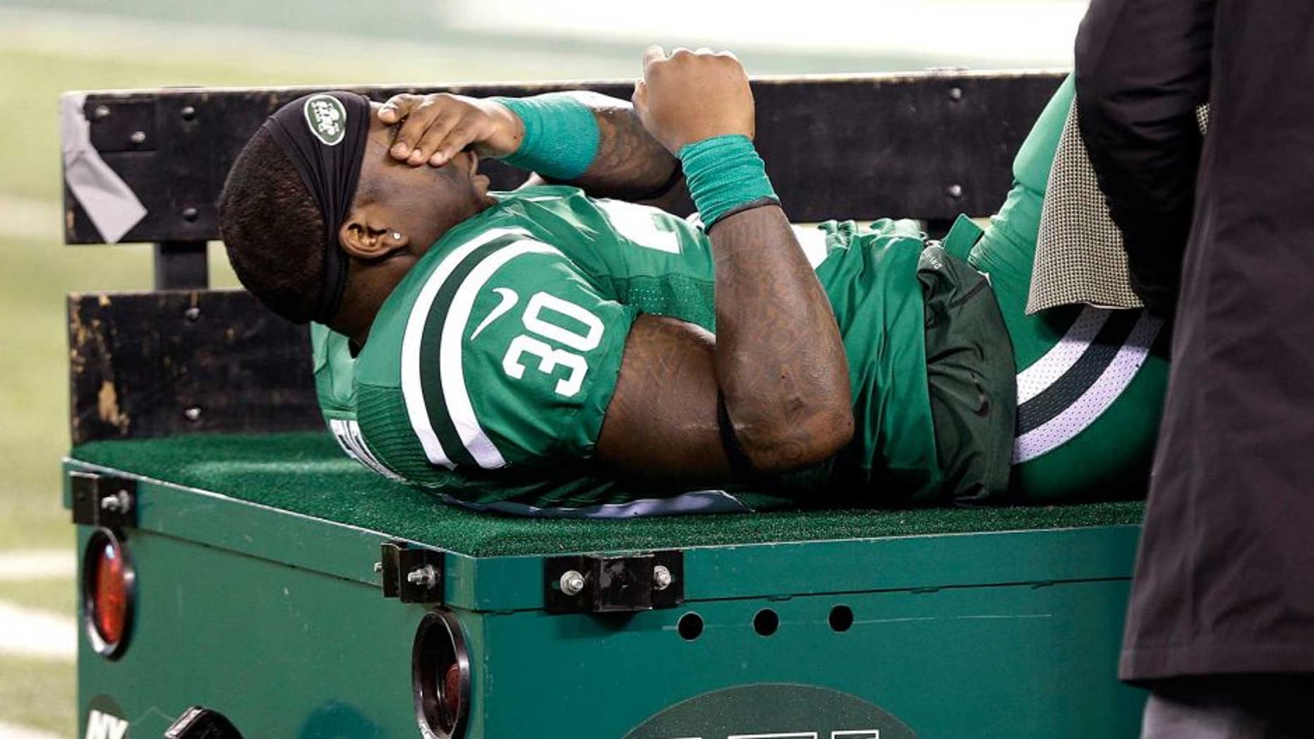 New York Jets running back Zac Stacy reacts as he is treated by trainers before being carted off the field during the first half of an NFL football game against the Buffalo Bills, Thursday, Nov. 12, 2015, in East Rutherford, N.J. (AP Photo/Seth Wenig)
