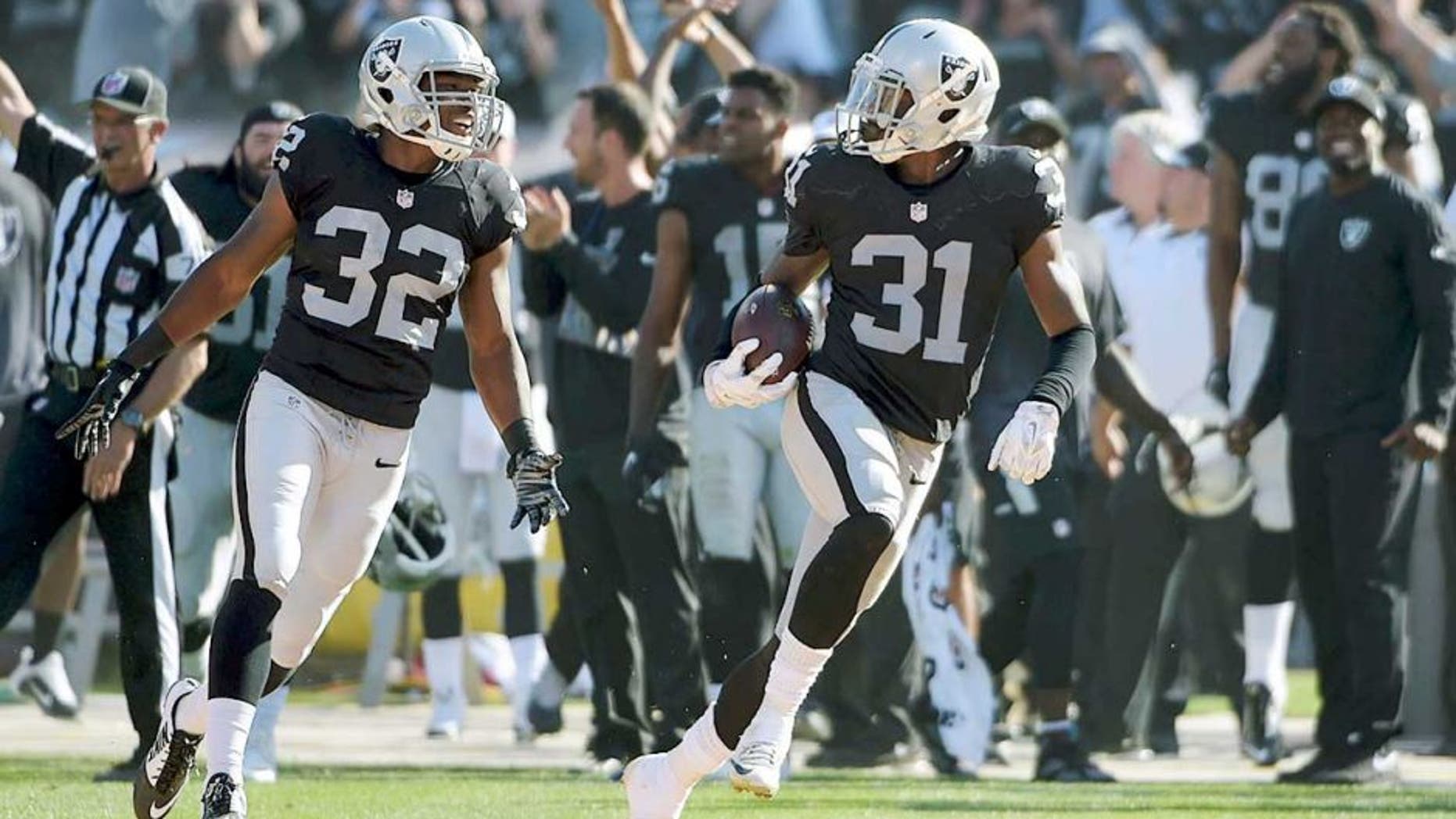 Sep 20, 2015; Oakland, CA, USA; Oakland Raiders cornerback Neiko Thorpe (31) celebrates with safety Keenan Lambert (32) after intercepting a pass in the final minute against the Baltimore Ravens as at O.co Coliseum. The Raiders defeated the Ravens 37-33. Mandatory Credit: Kirby Lee-USA TODAY Sports