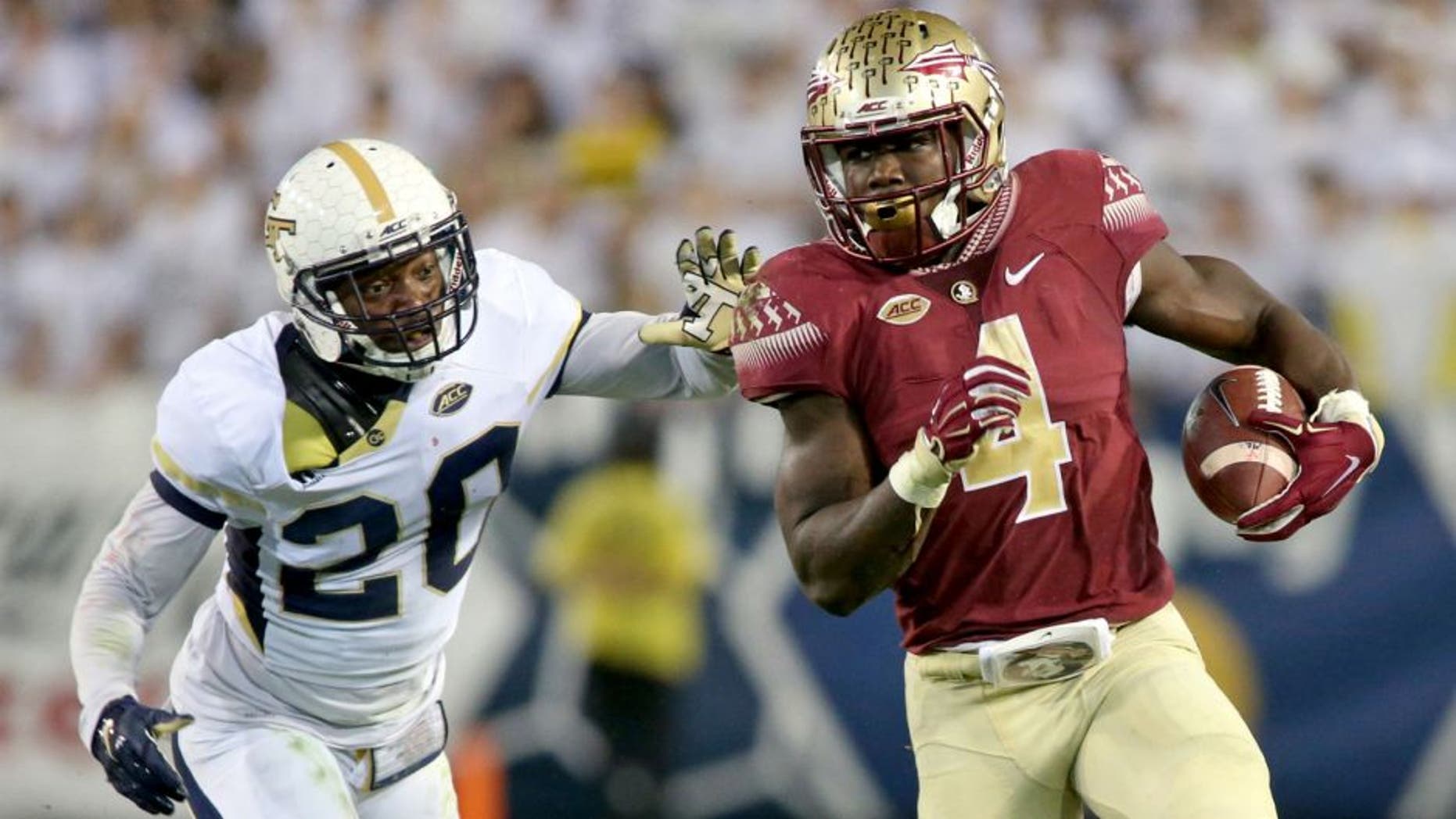 Oct 24, 2015; Atlanta, GA, USA; Florida State Seminoles running back Dalvin Cook (4) runs against Georgia Tech Yellow Jackets defensive back Lawrence Austin (20) in the second quarter of their game at Bobby Dodd Stadium. Mandatory Credit: Jason Getz-USA TODAY Sports