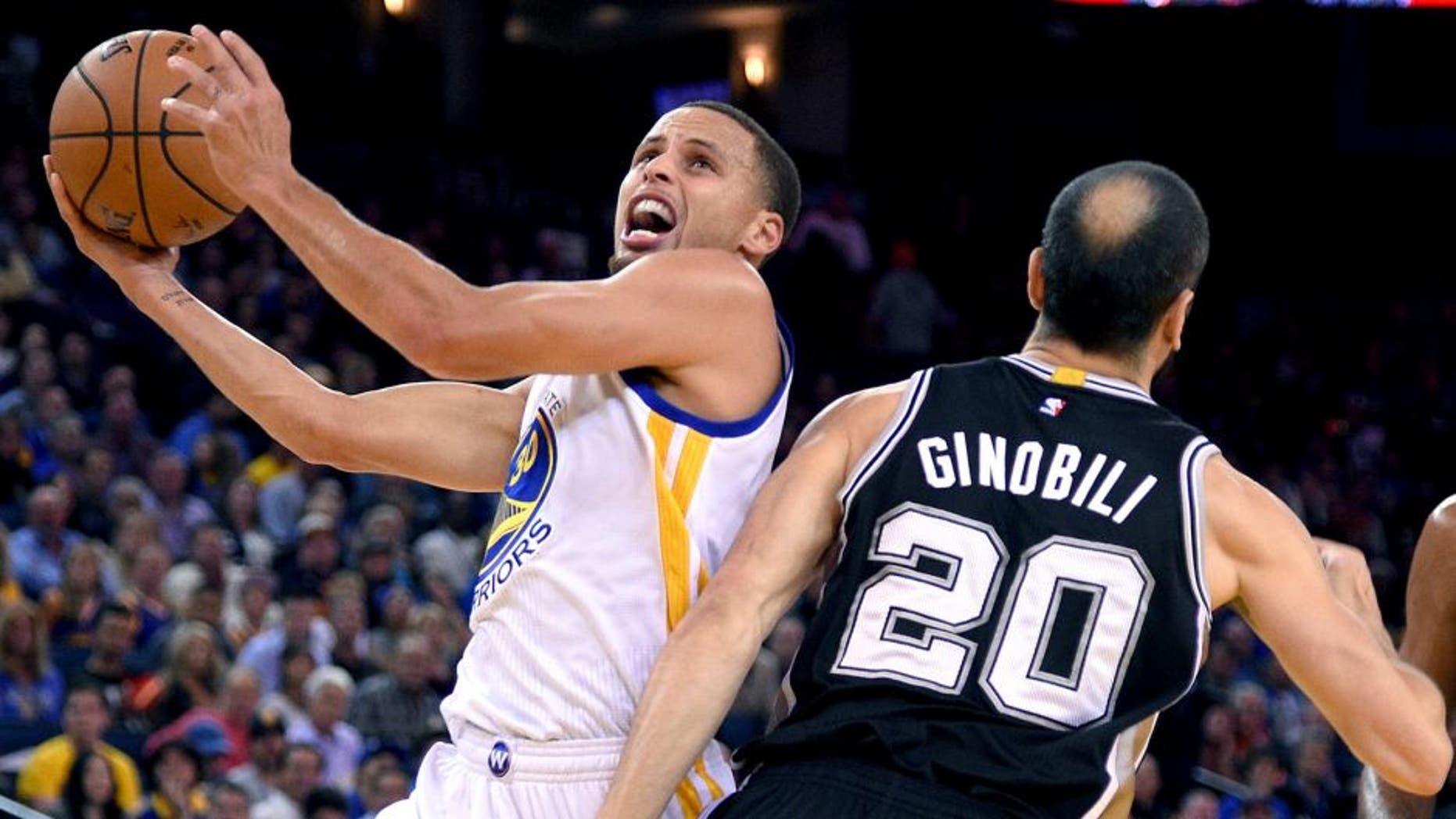 Nov 11, 2014; Oakland, CA, USA; Golden State Warriors guard Stephen Curry (30, left) shoots the ball against San Antonio Spurs guard Manu Ginobili (20) during the first quarter at Oracle Arena. Mandatory Credit: Kyle Terada-USA TODAY Sports
