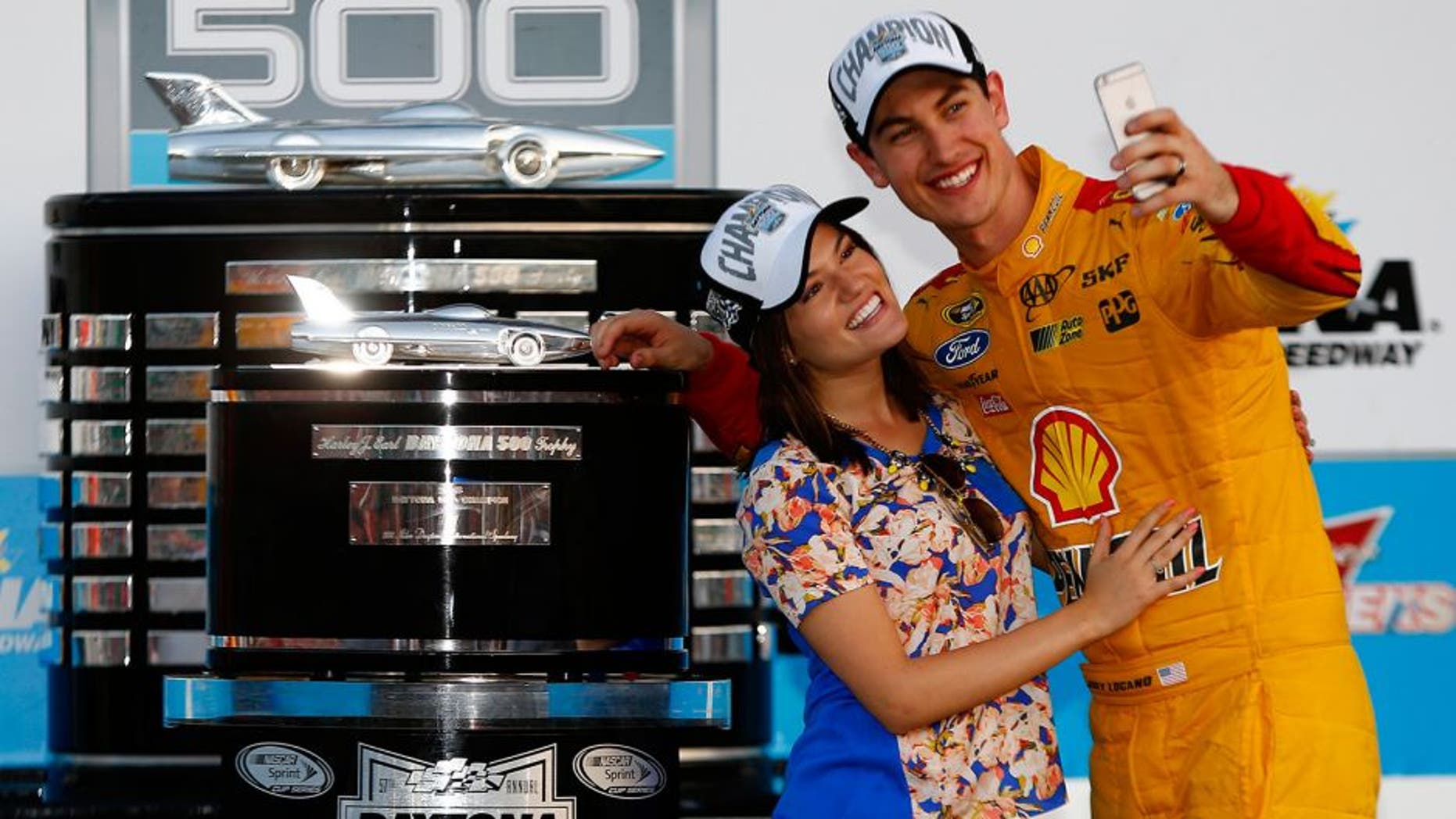 DAYTONA BEACH, FL - FEBRUARY 22: Joey Logano, driver of the #22 Shell Pennzoil Ford, and wife Brittany take a selfie in Victory Lane with The Harley J. Earl Trophy after winning the NASCAR Sprint Cup Series 57th Annual Daytona 500 at Daytona International Speedway on February 22, 2015 in Daytona Beach, Florida. (Photo by Jerry Markland/Getty Images)