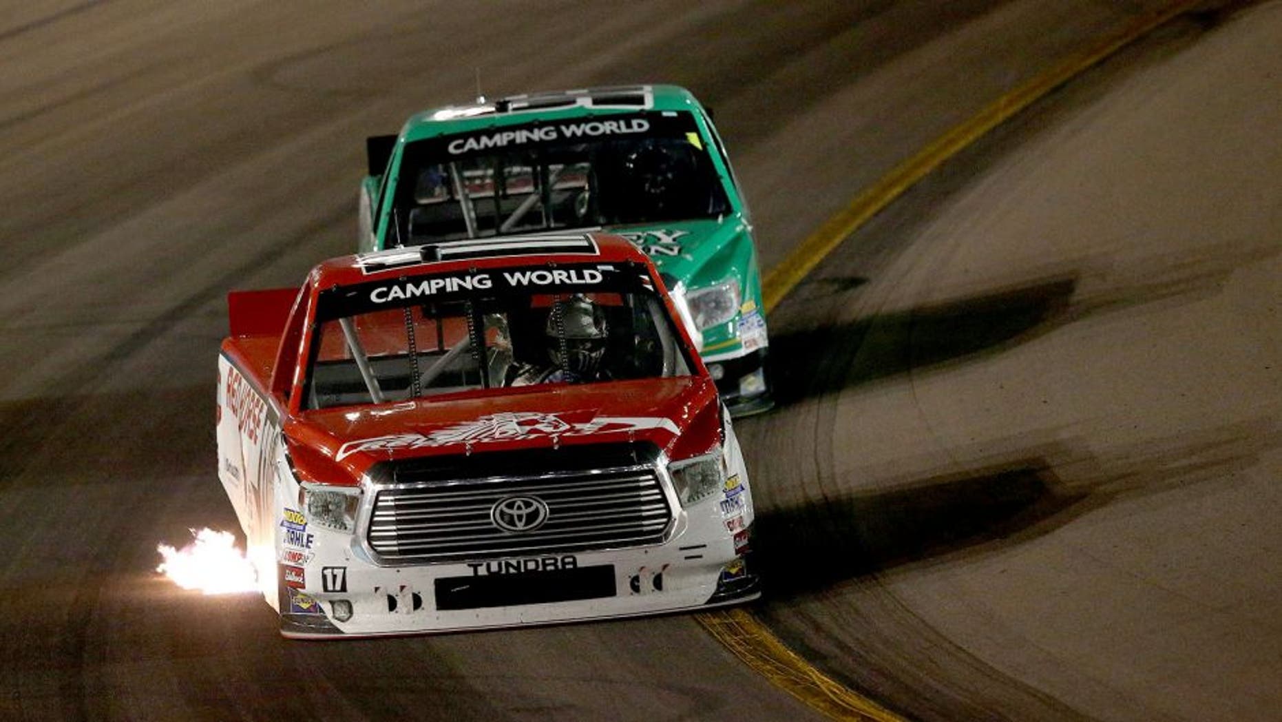 AVONDALE, AZ - NOVEMBER 13: Timothy Peters, driver of the #17 Red Horse Racing Toyota, leads Johnny Sauter, driver of the #98 Smokey Mountain/Curb Records Toyota, during the NASCAR Camping World Truck Series Lucas Oil 150 at Phoenix International Raceway on November 13, 2015 in Avondale, Arizona. (Photo by Sean Gardner/Getty Images)