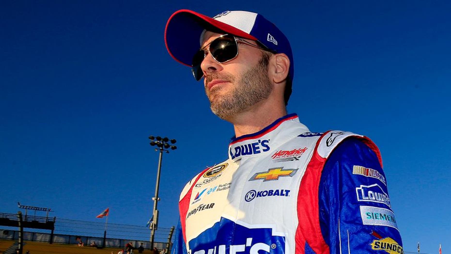 AVONDALE, AZ - NOVEMBER 13: Jimmie Johnson, driver of the #48 Lowe's Patriotic Chevrolet, walks on the grid during qualifying for the NASCAR Sprint Cup Series Quicken Loans Race for Heroes 500 at Phoenix International Raceway on November 13, 2015 in Avondale, Arizona. (Photo by Chris Trotman/Getty Images)