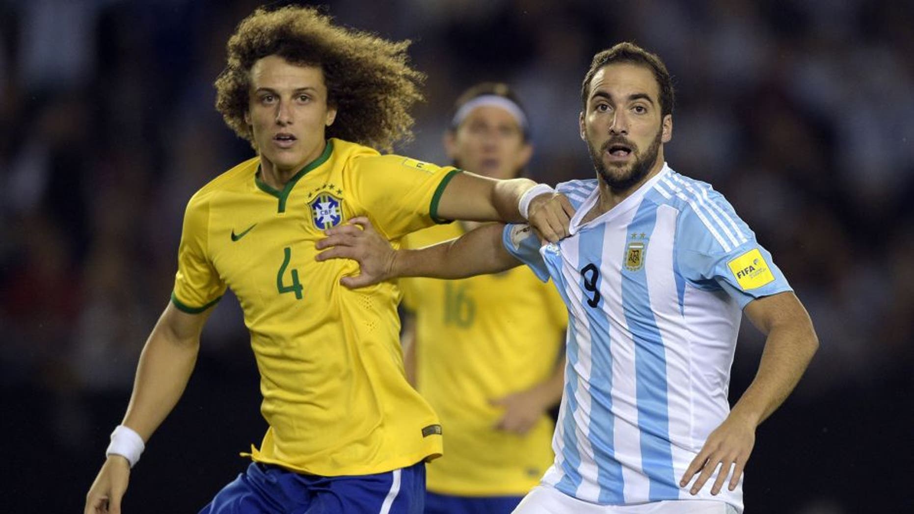 Brazil's David Luiz(L) and Argentina's Gonzalo Higuain vie during their Russia 2018 FIFA World Cup South American Qualifiers football match, in Buenos Aires, on November 13, 2015. AFP PHOTO / JUAN MABROMATA (Photo credit should read JUAN MABROMATA/AFP/Getty Images)