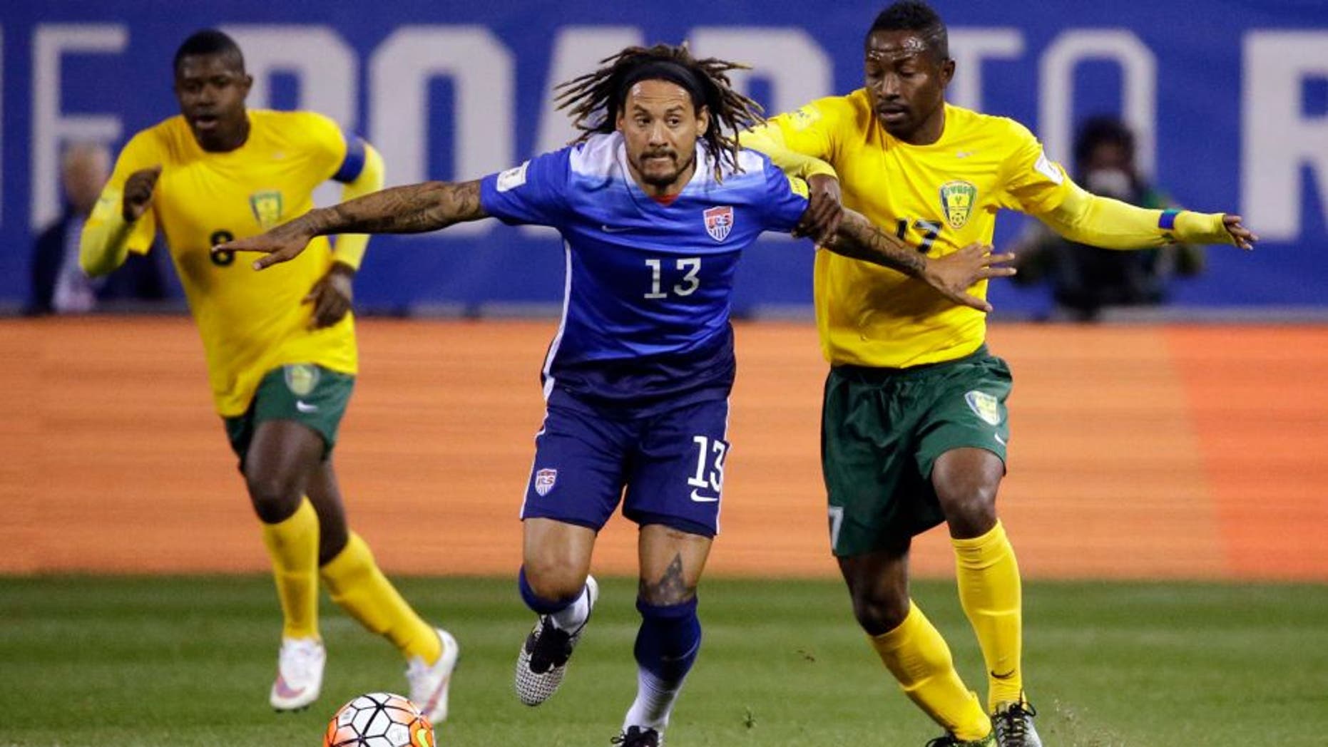 United Statesâ Jermaine Jones (13) controls the ball as St. Vincent and the Grenadinesâ Dorren Hamlet, left, and Seinard Bowens, right, defend during the first half of a 2018 World Cup qualifying soccer match Friday, Nov. 13, 2015, in St. Louis. (AP Photo/Jeff Roberson)