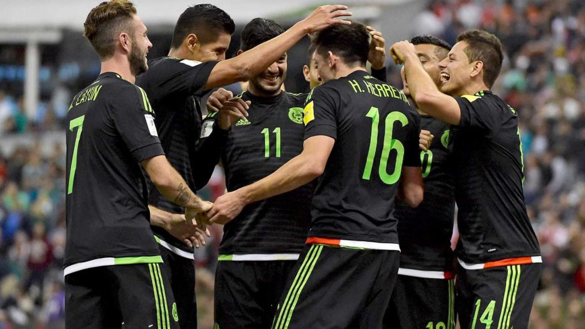 Mexico's Hector Herrera (16) celebrates with teammated after scoring against El Salvador during their Russia 2018 FIFA World Cup South American Qualifiers football match, in Mexico City on November 13, 2015. AFP PHOTO / ALFREDO ESTRELLA (Photo credit should read ALFREDO ESTRELLA/AFP/Getty Images)