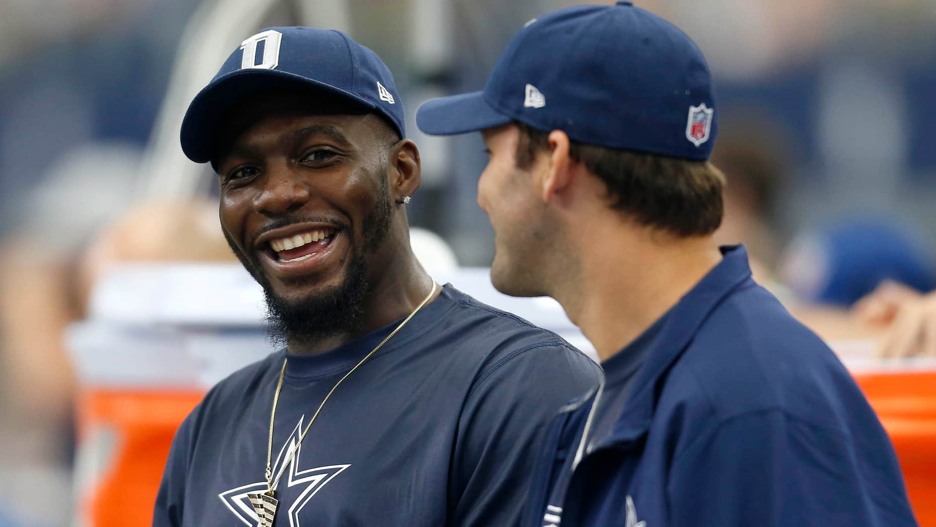 FILE - In this Sept. 27, 2015, file photo, Dallas Cowboys' Dez Bryant, left, and Tony Romo, right, talk on the sideline in the first half of an NFL football game against the Atlanta Falcons in Arlington, Texas.