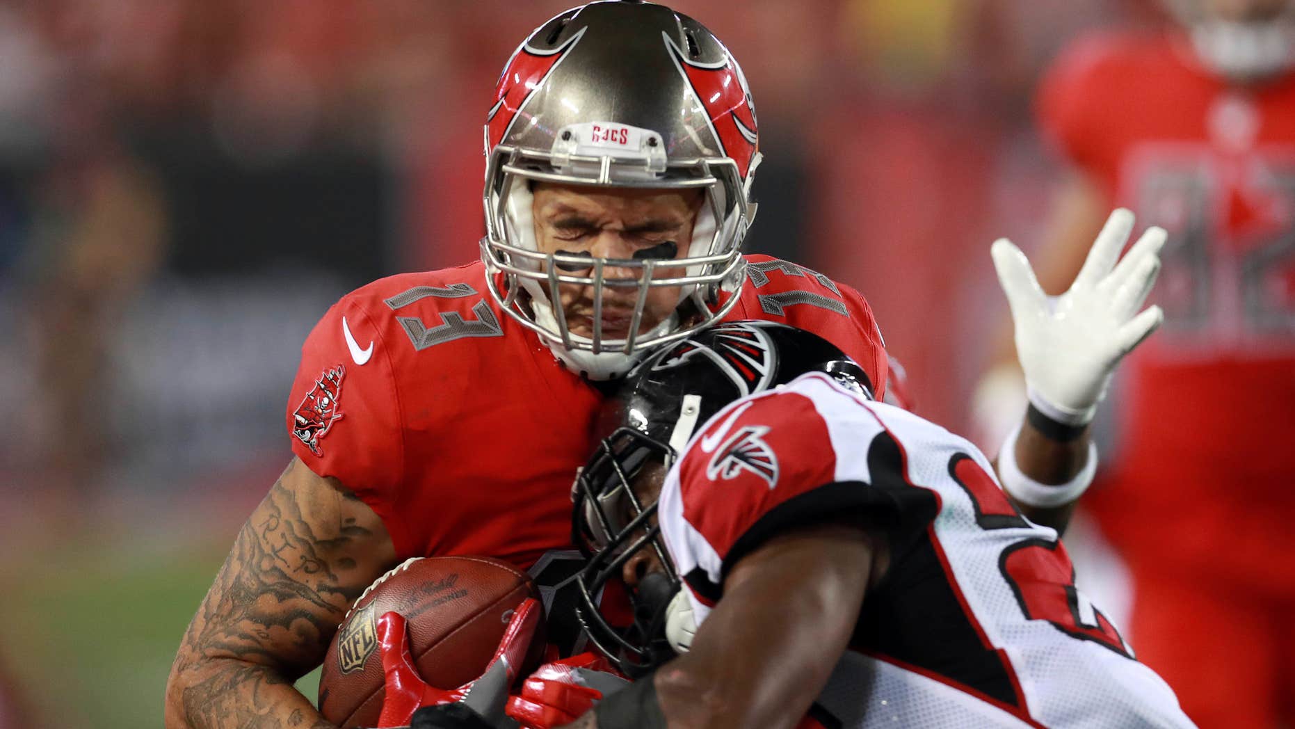 FILE - In this nov. 3, 2016, file photo, Tampa Bay Buccaneers wide receiver Mike Evans (13) makes catch as Atlanta Falcons safety Keanu Neal (22) tackles him during an NFL football game in Tampa, Fla.