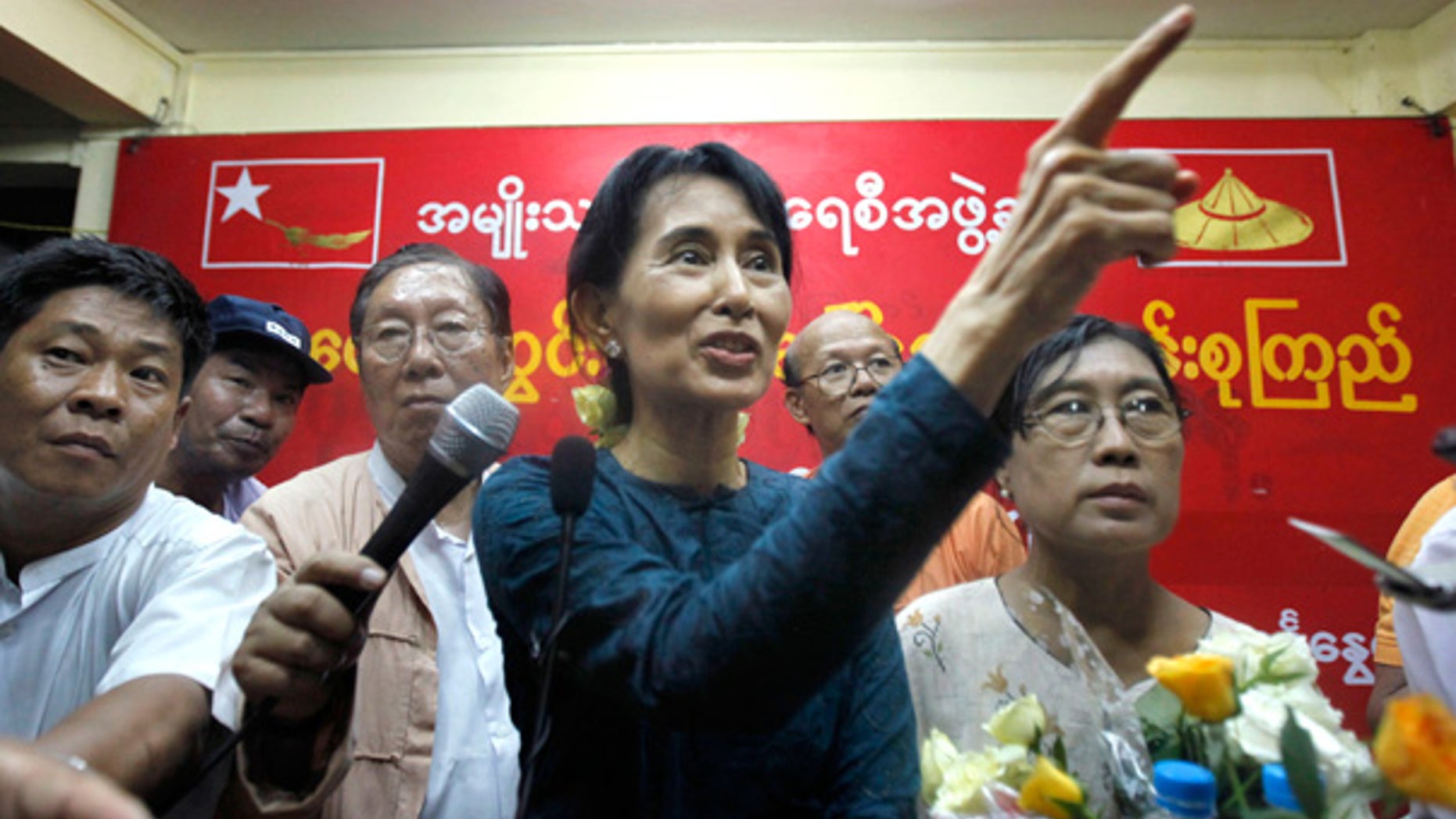 Nov. 14: Pro-democracy leader Aung San Suu Kyi gestures during her first press conference since her release from house arrest in Rangoon, Burma.