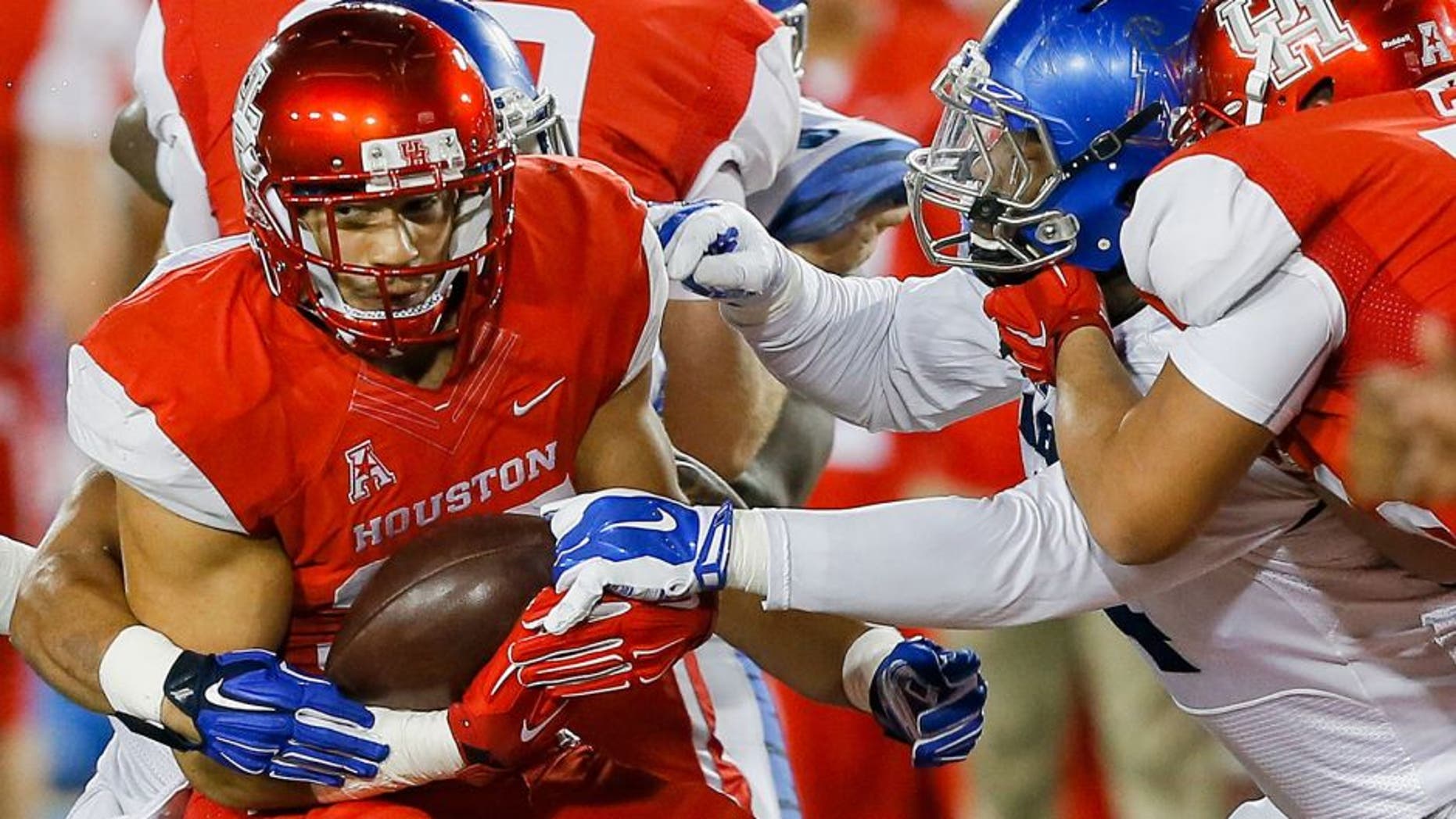 HOUSTON, TX - NOVEMBER 14: Kenneth Farrow #35 of the Houston Cougars is tackled by the Memphis Tigers in the second quarter on November 14, 2015 in Houston, Texas. (Photo by Bob Levey/Getty Images)