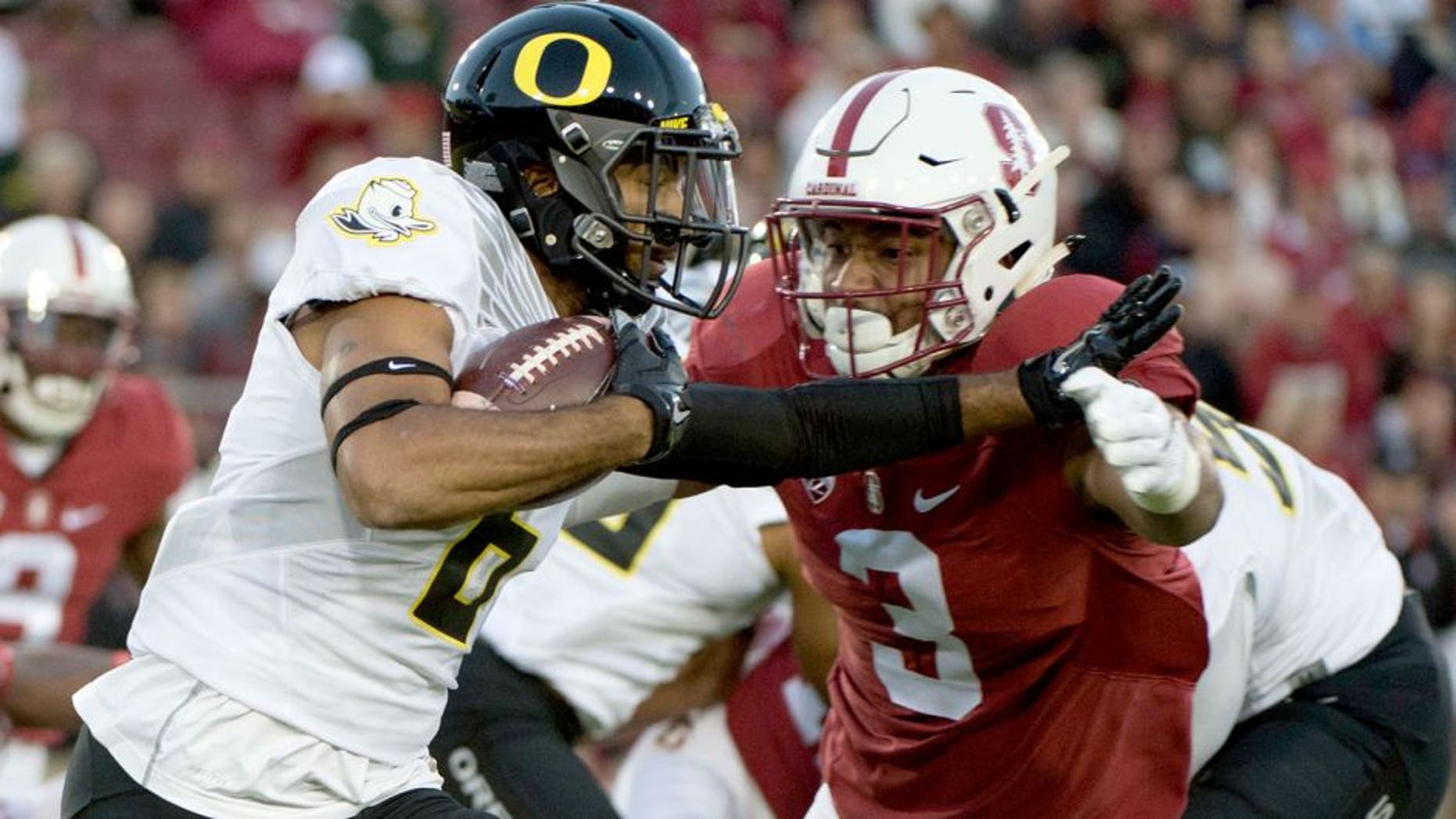 November 14, 2015; Stanford, CA, USA; Oregon Ducks wide receiver Charles Nelson (6) runs with the football against Stanford Cardinal linebacker Noor Davis (3) during the first quarter at Stanford Stadium. Mandatory Credit: Kyle Terada-USA TODAY Sports