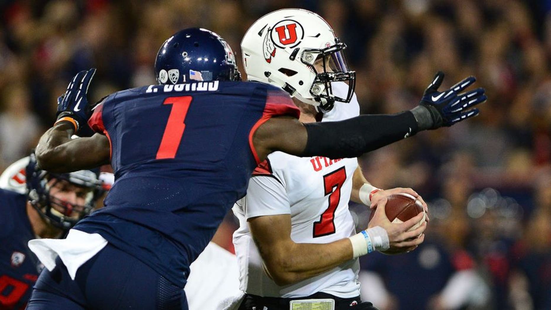 TUCSON, AZ - NOVEMBER 14: Quarterback Travis Wilson #7 of the Utah Utes is sacked by safety Tellas Jones #1 of the Arizona Wildcats in the first quarter of the game at Arizona Stadium on November 14, 2015 in Tucson, Arizona. (Photo by Jennifer Stewart/Getty Images)