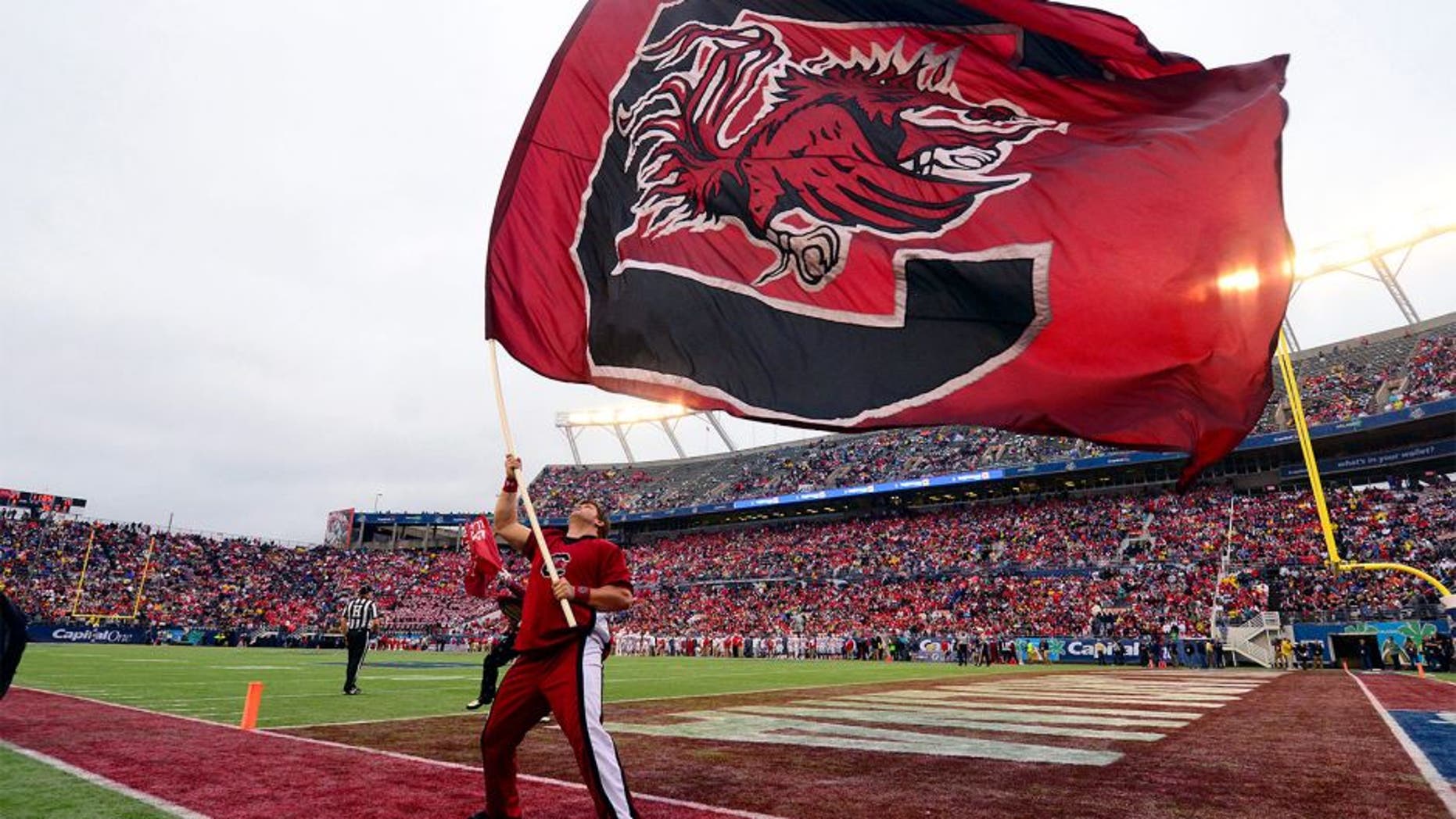 Jan 1, 2014; Orlando, FL, USA; The South Carolina Gamecocks flag flies after a score as they beat the Wisconsin Badgers 34-24 in the Capital One Bowl at Florida Citrus Bowl. Mandatory Credit: David Manning-USA TODAY Sports