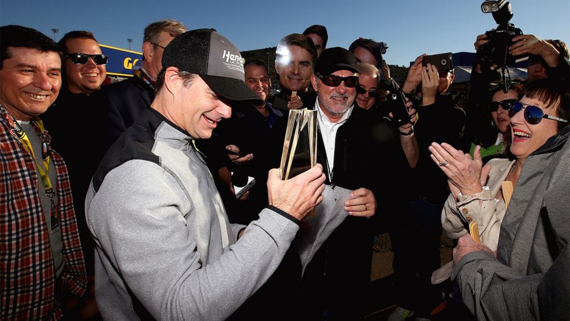 AVONDALE, AZ - NOVEMBER 14: Jeff Gordon, driver of the #24 Pepsi Chevrolet, poses for a photo with members of the media before practice for the NASCAR Sprint Cup Series Quicken Loans Race for Heroes 500 at Phoenix International Raceway on November 14, 2015 in Avondale, Arizona. (Photo by Sean Gardner/Getty Images)