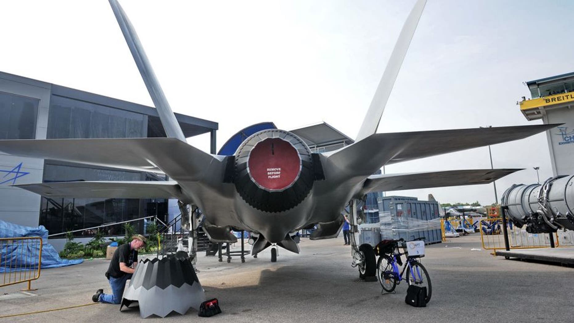 A staff member prepares the replica of Lockheed Martin F-35 fighter jet at the exhibition centre ahead of the Singapore's Airshow on February 9, 2014. Asia's top aerospace and defence show opens on February 11 in Singapore with major global arms makers seeking to cash in on rising military spending as territorial disputes escalate in the region. AFP PHOTO / ROSLAN RAHMAN (Photo credit should read ROSLAN RAHMAN/AFP/Getty Images)
