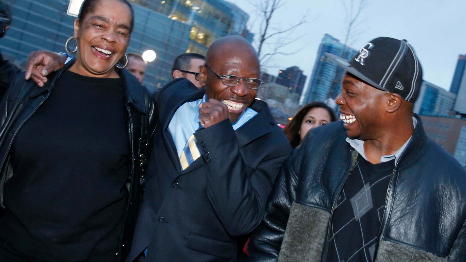 FILE - In this Dec. 22, 2015, file photo, Clarence Moses-EL, center, flanked by his wife Stephanie Burke, left, and an unidentified man jokes after his release from the Denver County jail in Denver