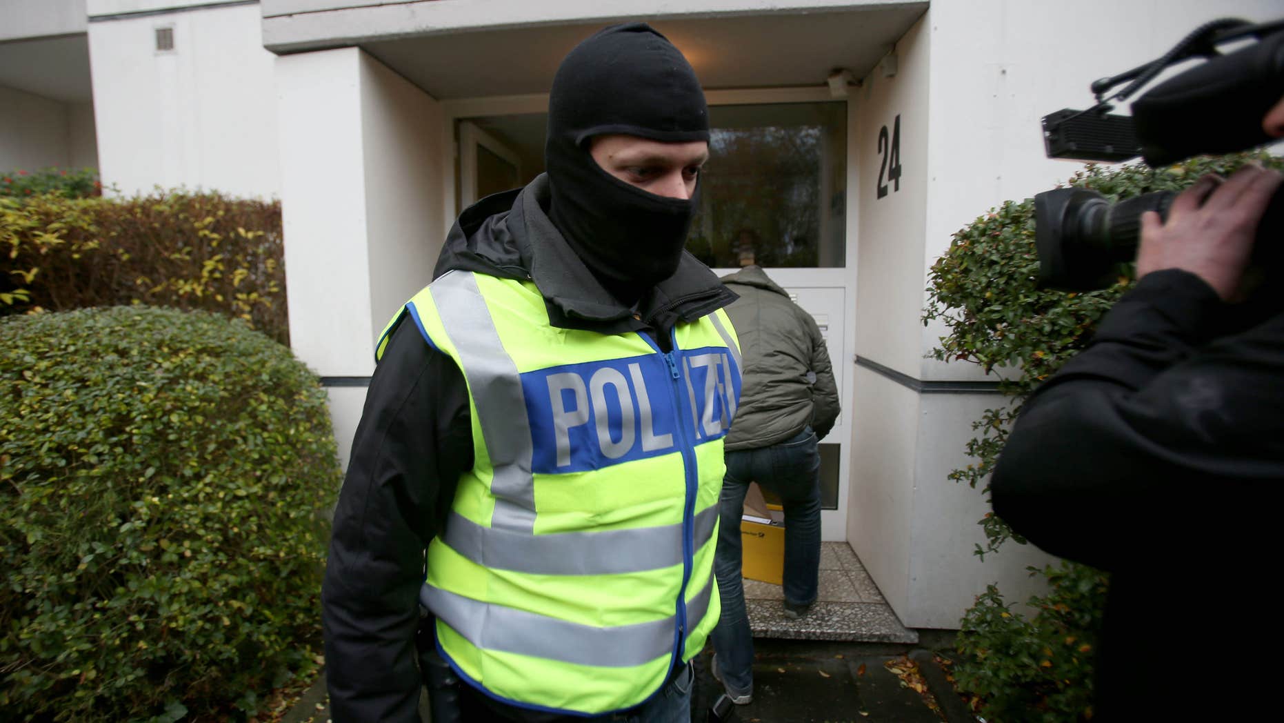 Nov. 15, 2016: Police officers leave a residential house which has been searched in Bonn, western Germany.