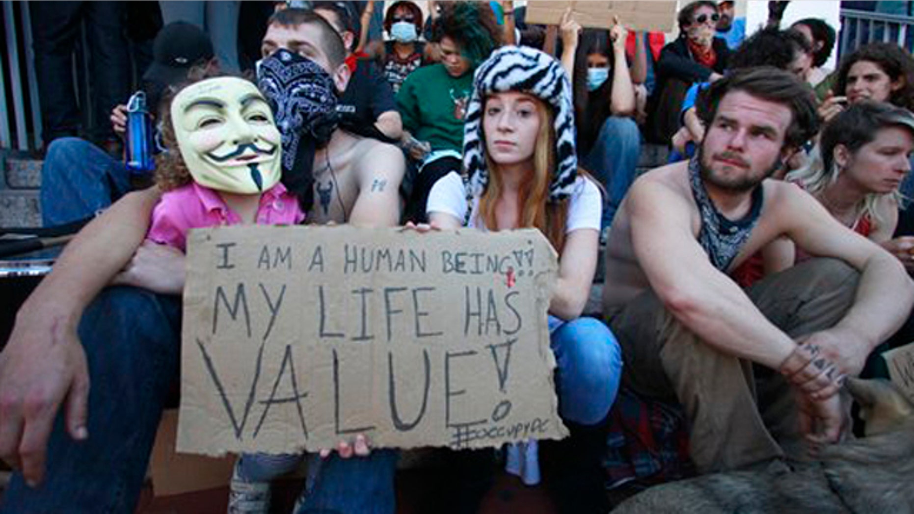 November 7, 2011: Protestors who would only give their first name Cody, left, and Nicole, center, join protestors gathered on the steps of the District of Columbia Metropolitan Police headquarter in Washington.