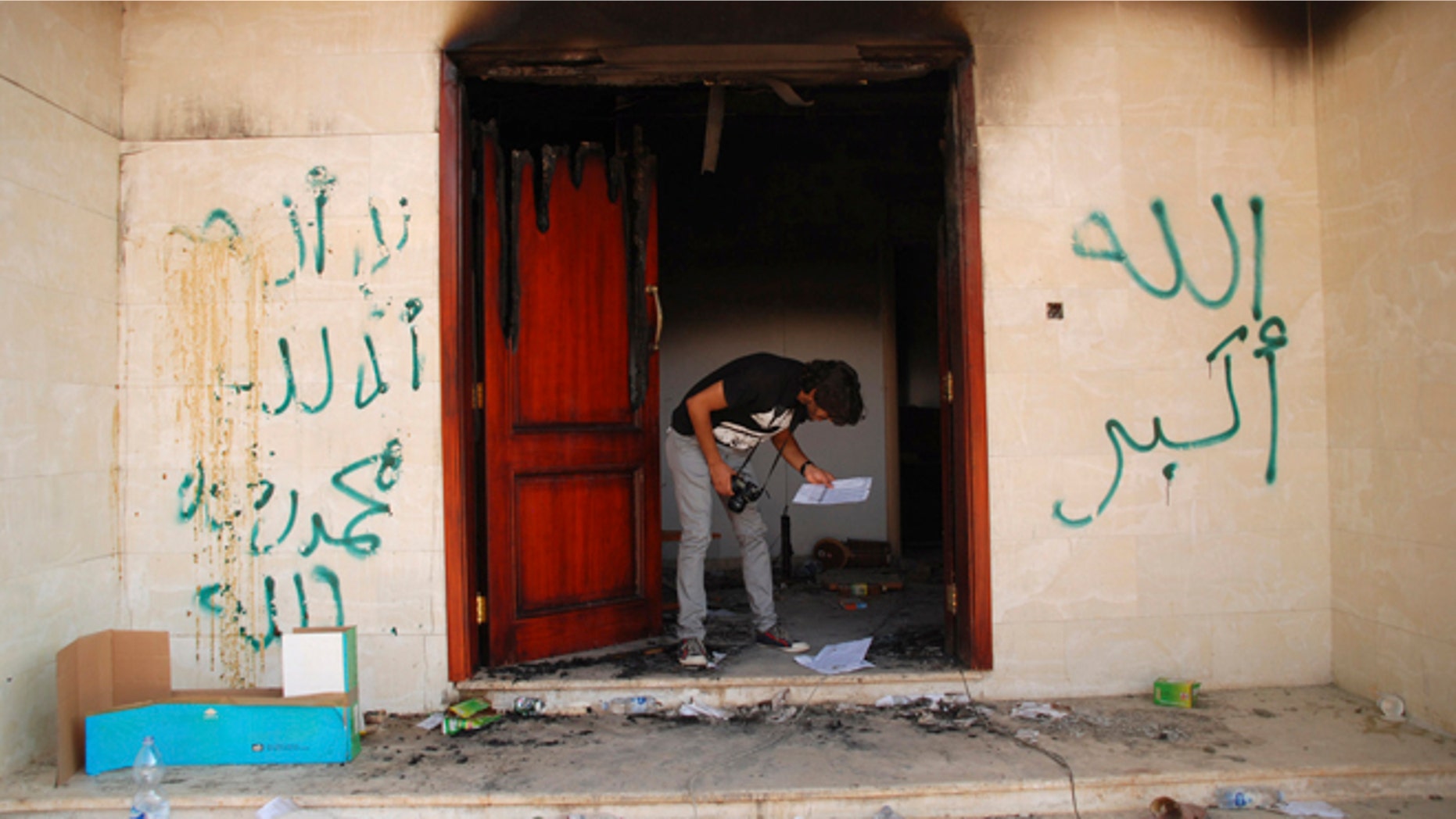 Sept. 12, 2012: A man looks at documents at the U.S. consulate in Benghazi, Libya, after an attack that killed four Americans, including Ambassador Chris Stevens.