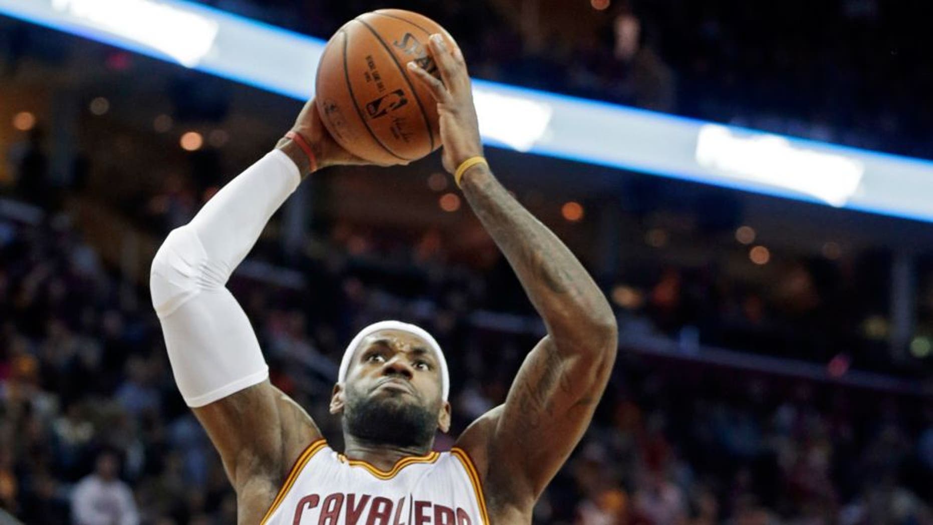 Cleveland Cavaliers' LeBron James (23) goes in for a dunk on Atlanta Hawks' Jeff Teague in the first quarter of an NBA basketball game Saturday, Nov. 15, 2014, in Cleveland. (AP Photo/Mark Duncan)