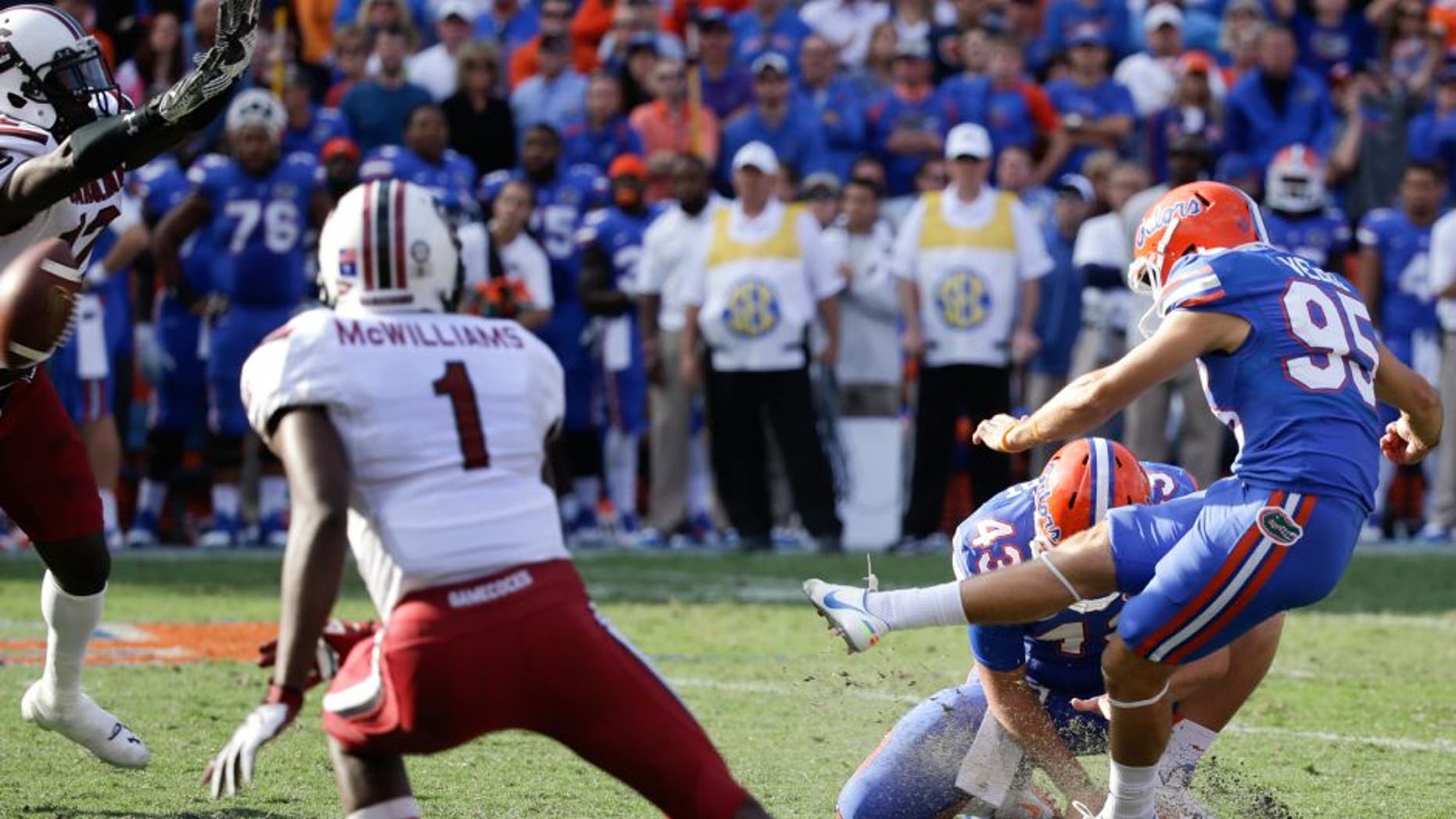South Carolina safety Brison Williams, far left, blocks a field goal attempt by Florida place kicker Francisco Velez (95) during the second half of an NCAA college football game in Gainesville, Fla., Saturday, Nov. 15, 2014. South Carolina won in overtime 23-20. (AP Photo/John Raoux)
