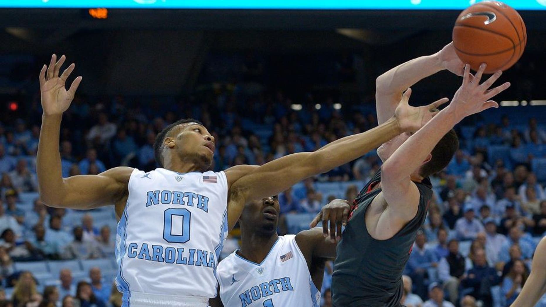CHAPEL HILL, NC - NOVEMBER 15: Nate Britt #0 and Theo Pinson #1 of the North Carolina Tar Heels battle Matija Milin #34 of the Fairfield Stags during the first half of their game at the Dean Smith Center on November 15, 2015 in Chapel Hill, North Carolina. (Photo by Grant Halverson/Getty Images)