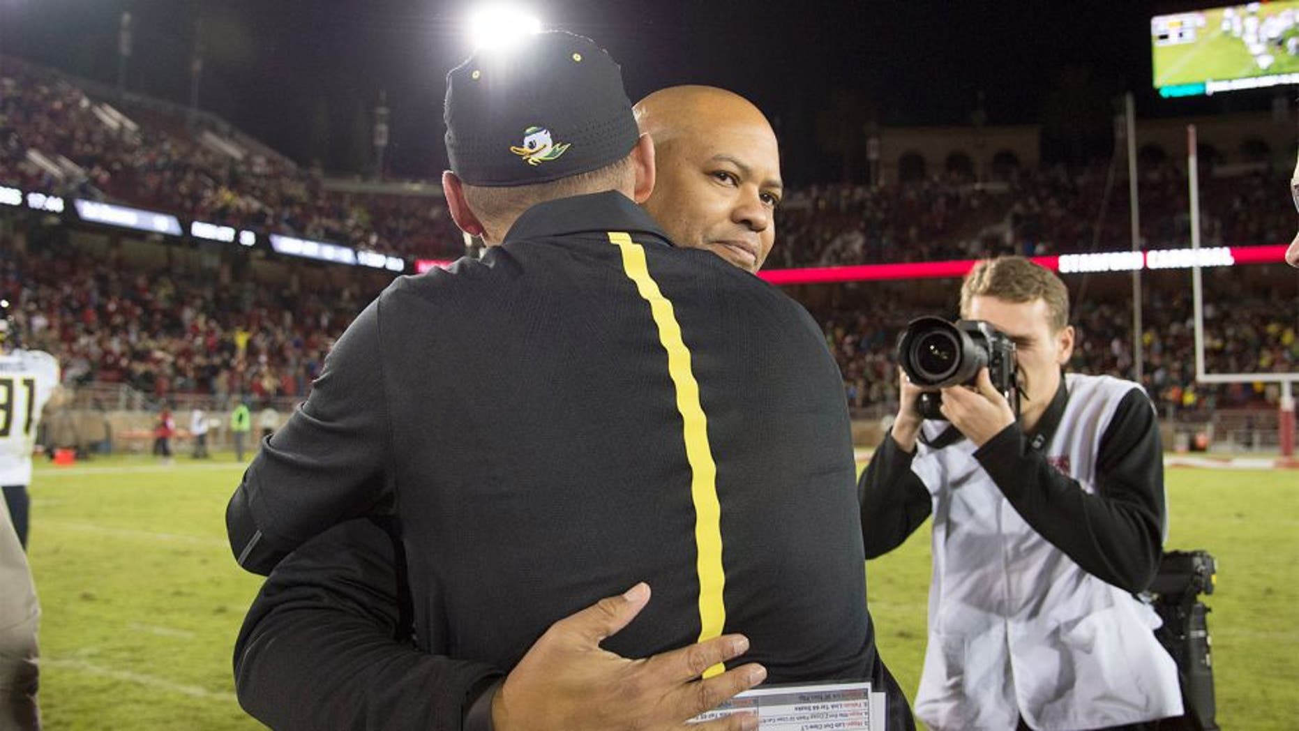 November 14, 2015; Stanford, CA, USA; Stanford Cardinal head coach David Shaw hugs Oregon Ducks head coach Mark Helfrich after the game at Stanford Stadium. The Ducks defeated the Cardinal 38-36. Mandatory Credit: Kyle Terada-USA TODAY Sports