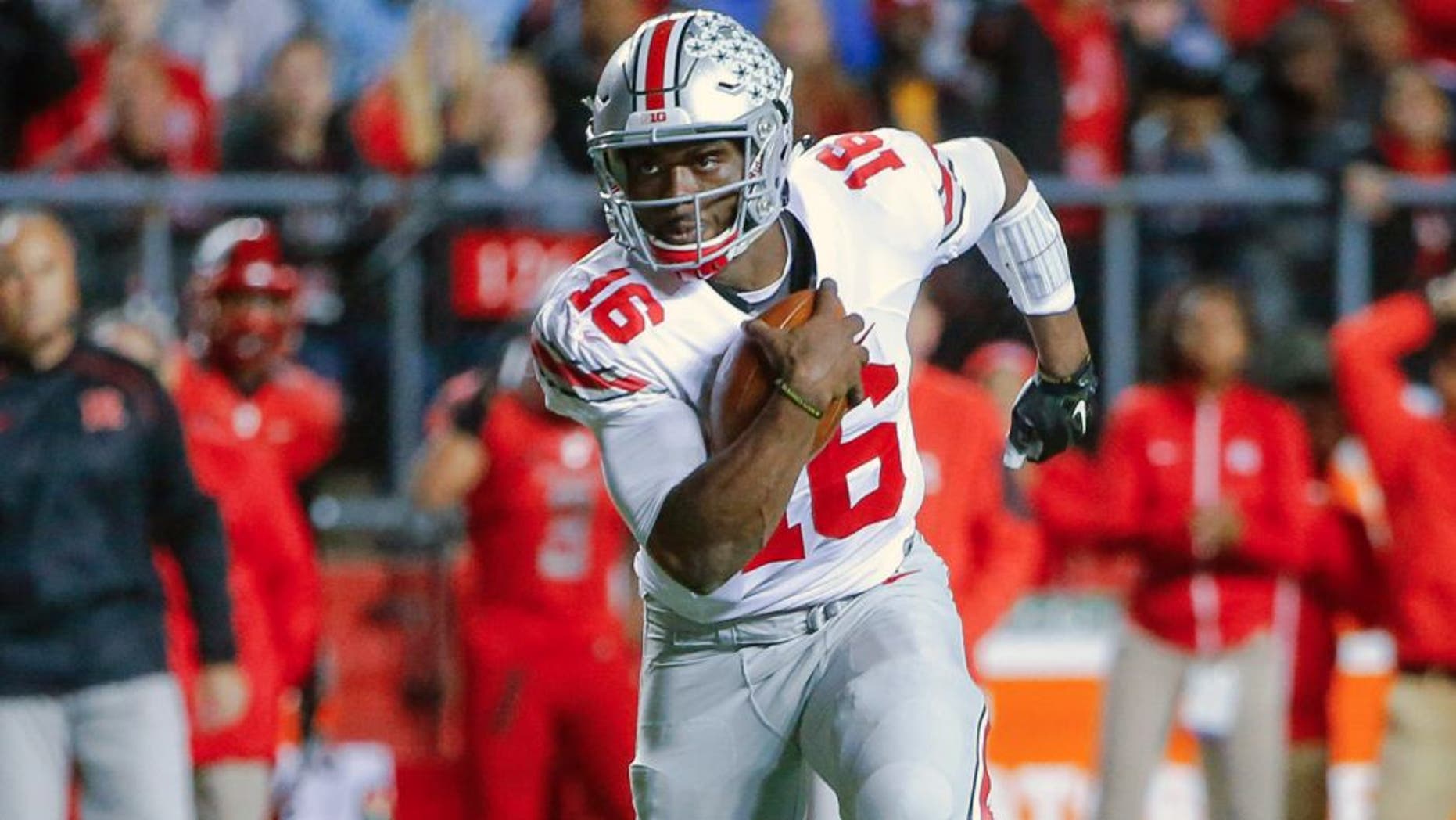 Oct 24, 2015; Piscataway, NJ, USA; Ohio State Buckeyes quarterback J.T. Barrett (16) turns up field during the first quarter against the Rutgers Scarlet Knights at High Points Solutions Stadium. Mandatory Credit: Jim O'Connor-USA TODAY Sports