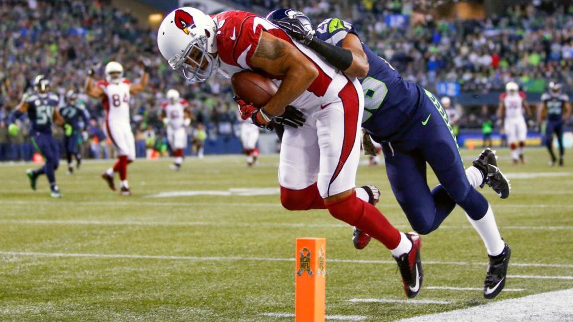 Nov 15, 2015; Seattle, WA, USA; Arizona Cardinals wide receiver Michael Floyd (15) catches a touchdown pass against Seattle Seahawks cornerback Cary Williams (26) during the second quarter at CenturyLink Field. Mandatory Credit: Joe Nicholson-USA TODAY Sports