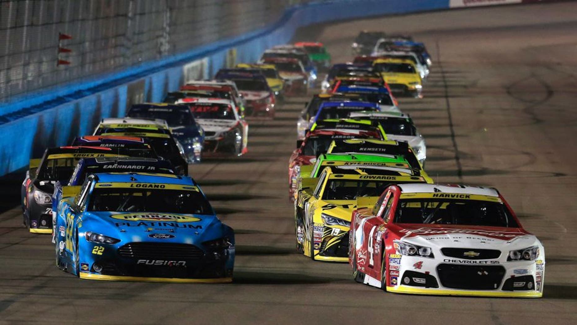 AVONDALE, AZ - NOVEMBER 15: Kurt Busch, driver of the #41 Haas Automation Chevrolet, and Joey Logano, driver of the #22 Pennzoil Ford, lead the field during the NASCAR Sprint Cup Series Quicken Loans Race for Heroes 500 at Phoenix International Raceway on November 15, 2015 in Avondale, Arizona. (Photo by Chris Trotman/Getty Images)