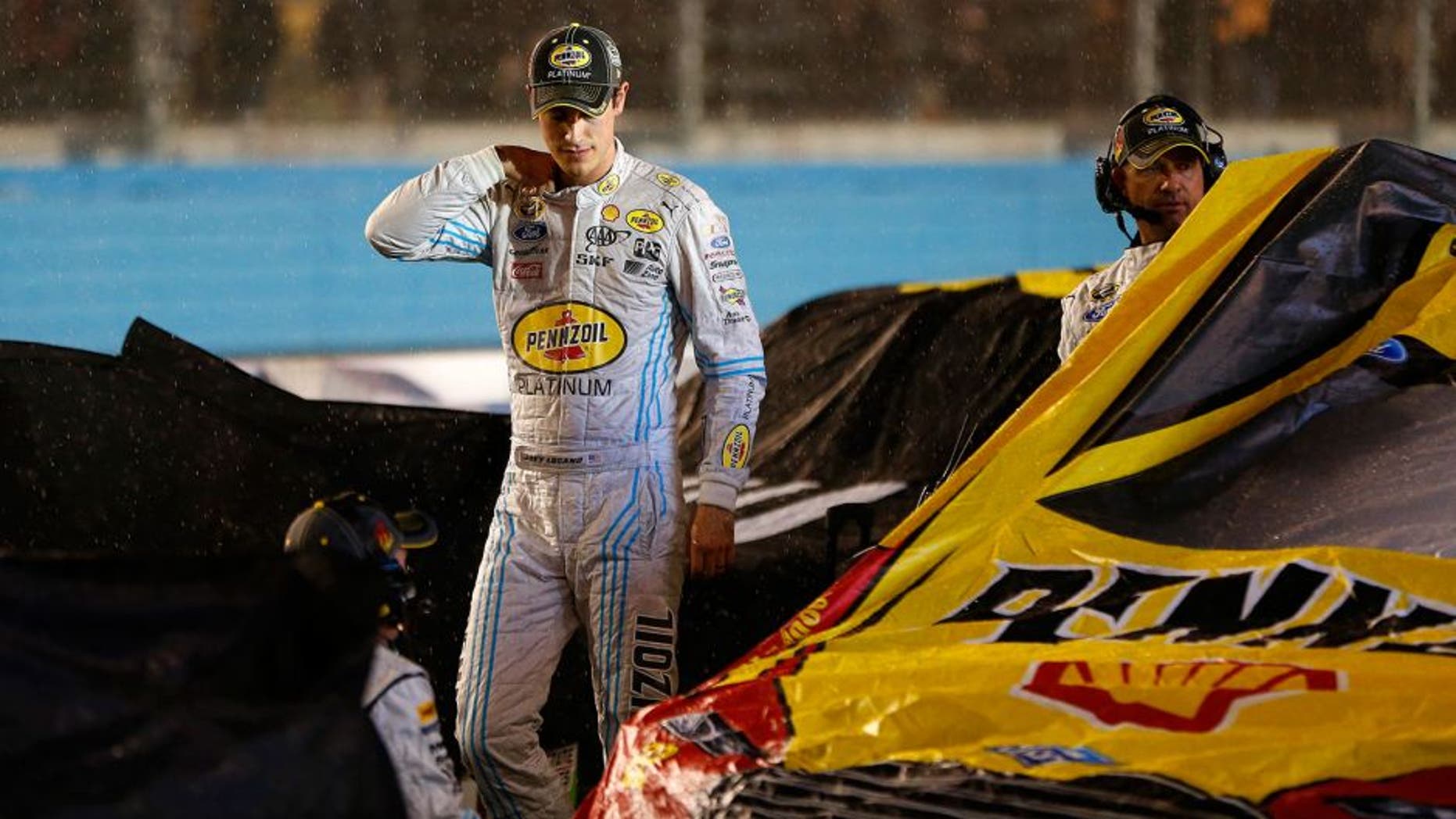 AVONDALE, AZ - NOVEMBER 15: Joey Logano, driver of the #22 Pennzoil Ford, stands on pit road during a red flag rain delay in the NASCAR Sprint Cup Series Quicken Loans Race for Heroes 500 at Phoenix International Raceway on November 15, 2015 in Avondale, Arizona. (Photo by Jonathan Ferrey/Getty Images)