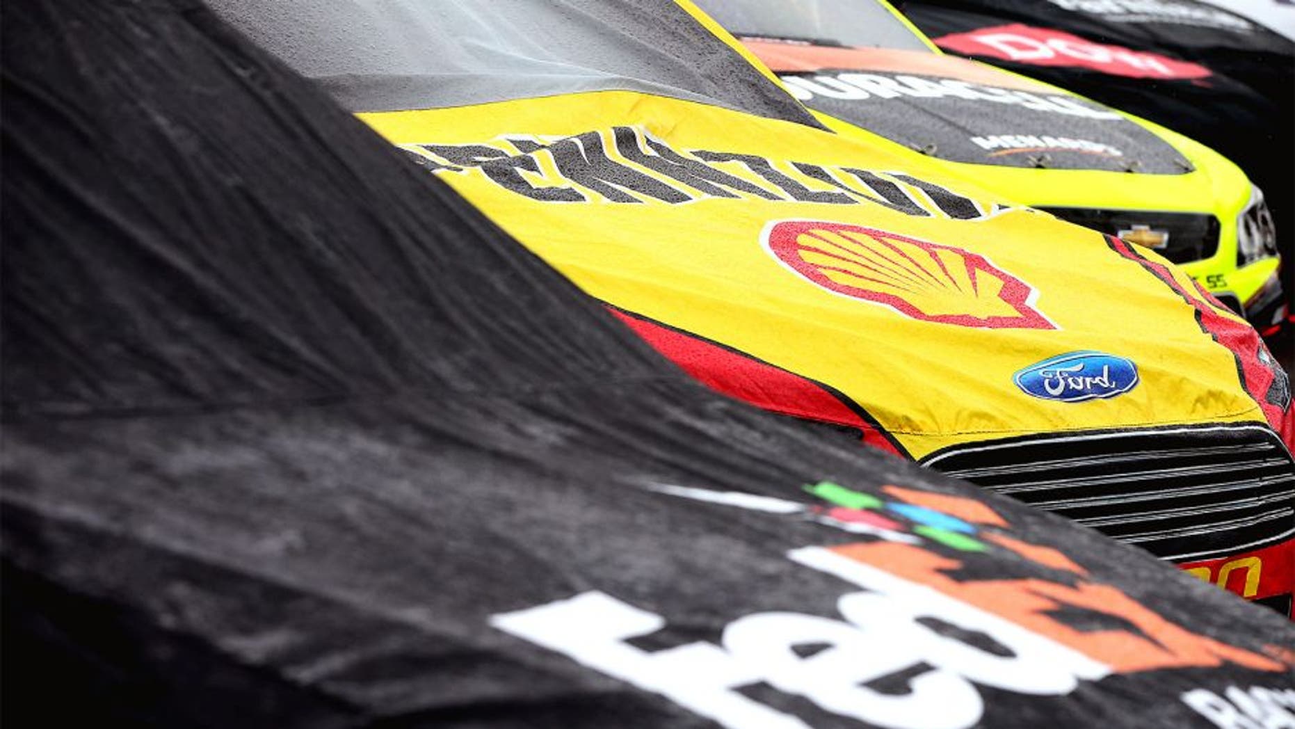 AVONDALE, AZ - NOVEMBER 15: Cars are seen covered on pit during a rain delay in the NASCAR Sprint Cup Series Quicken Loans Race for Heroes 500 at Phoenix International Raceway on November 15, 2015 in Avondale, Arizona. (Photo by Sean Gardner/Getty Images)