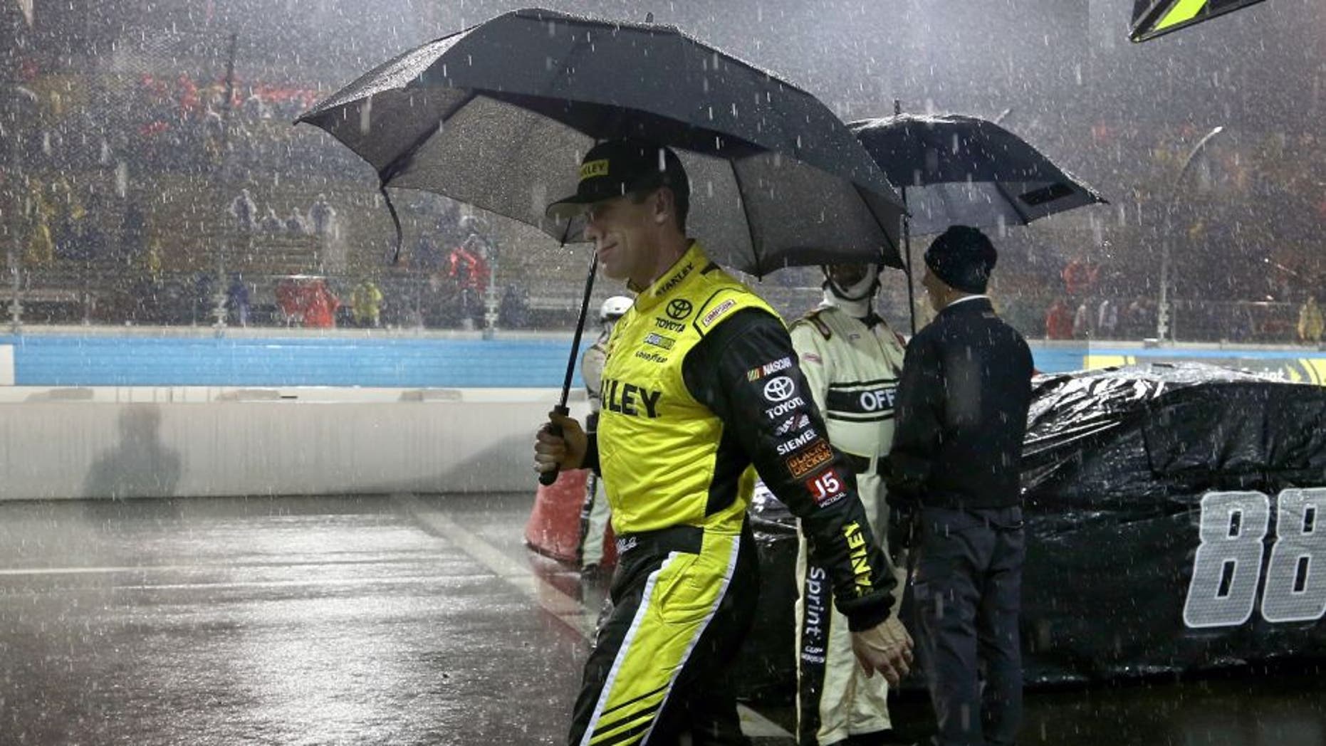 AVONDALE, AZ - NOVEMBER 15: Carl Edwards, driver of the #19 Stanley Toyota, walks off pit road in the rain during the NASCAR Sprint Cup Series Quicken Loans Race for Heroes 500 at Phoenix International Raceway on November 15, 2015 in Avondale, Arizona. (Photo by Matt Sullivan/NASCAR via Getty Images)