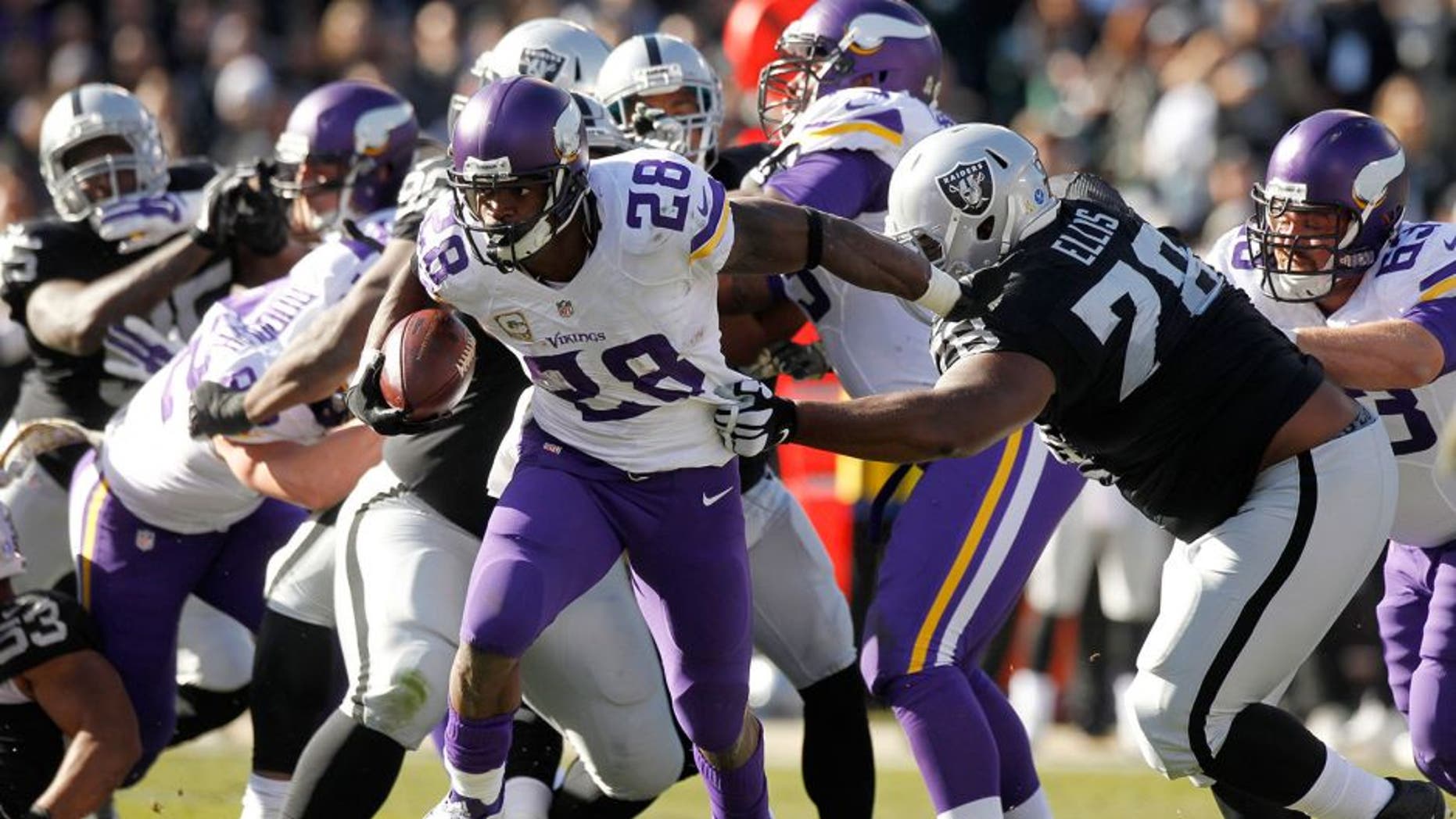 Nov 15, 2015; Oakland, CA, USA; Minnesota Vikings running back Adrian Peterson (28) runs the ball against the Oakland Raiders in the first quarter at O.co Coliseum. Mandatory Credit: Cary Edmondson-USA TODAY Sports