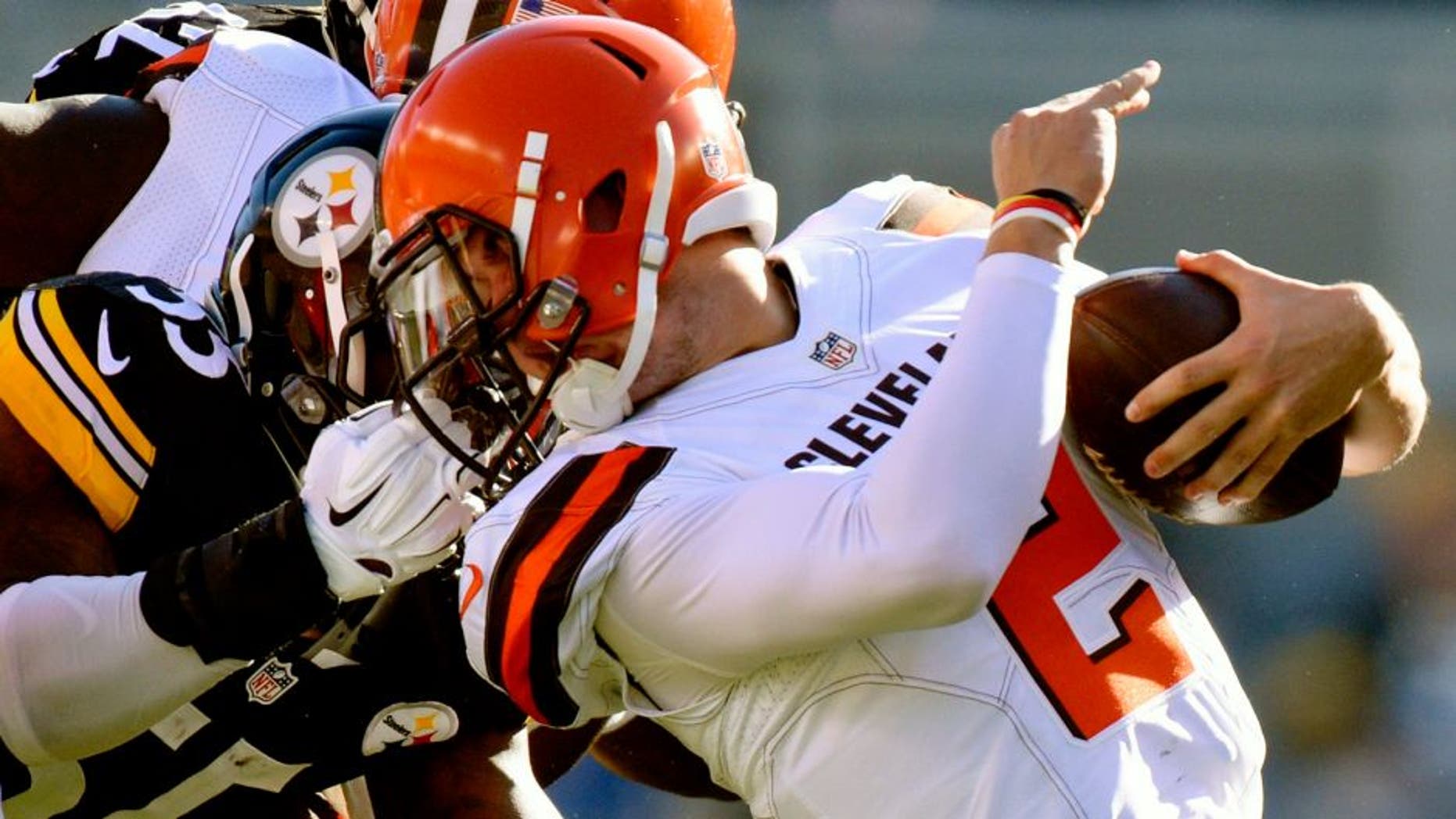 Cleveland Browns quarterback Johnny Manziel (2) is tackled by the face mask by Pittsburgh Steelers outside linebacker Arthur Moats (55) in the second quarter of an NFL football game, Sunday, Nov. 15, 2015, in Pittsburgh. Moats was penalized on the play. (AP Photo/Don Wright)
