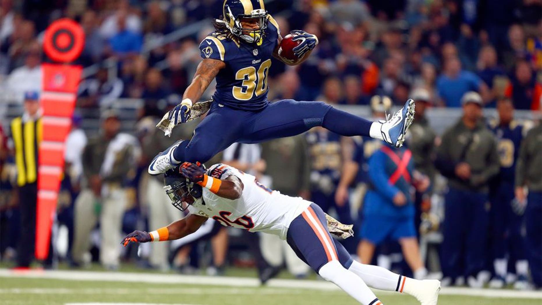 ST. LOUIS, MO - NOVEMBER 15: Todd Gurley #30 of the St. Louis Rams leaps over Antrel Rolle #26 of the Chicago Bears as he carries the ball in the first quarter at the Edward Jones Dome on November 15, 2015 in St. Louis, Missouri. (Photo by Dilip Vishwanat/Getty Images)