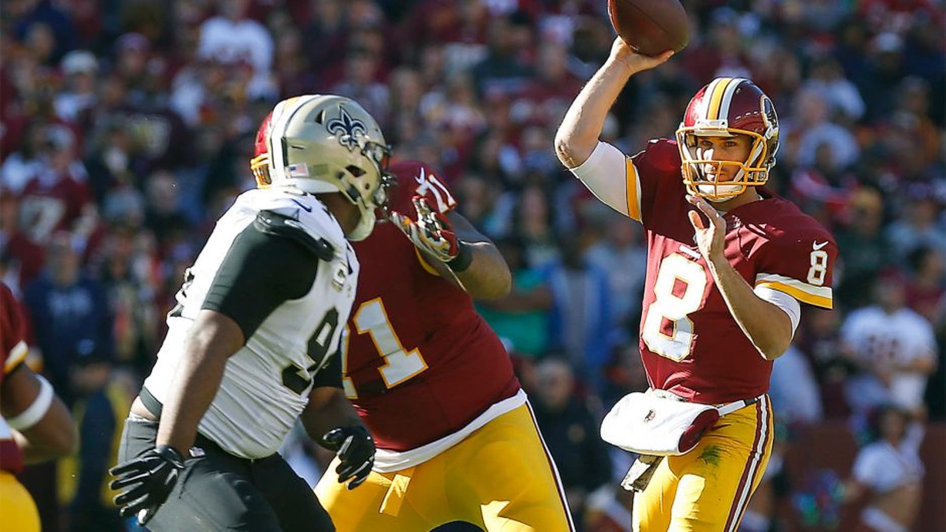 Nov 15, 2015; Landover, MD, USA; Washington Redskins quarterback Kirk Cousins (8) throws the ball over New Orleans Saints outside linebacker Kasim Edebali (91) in the first quarter at FedEx Field. Mandatory Credit: Geoff Burke-USA TODAY Sports