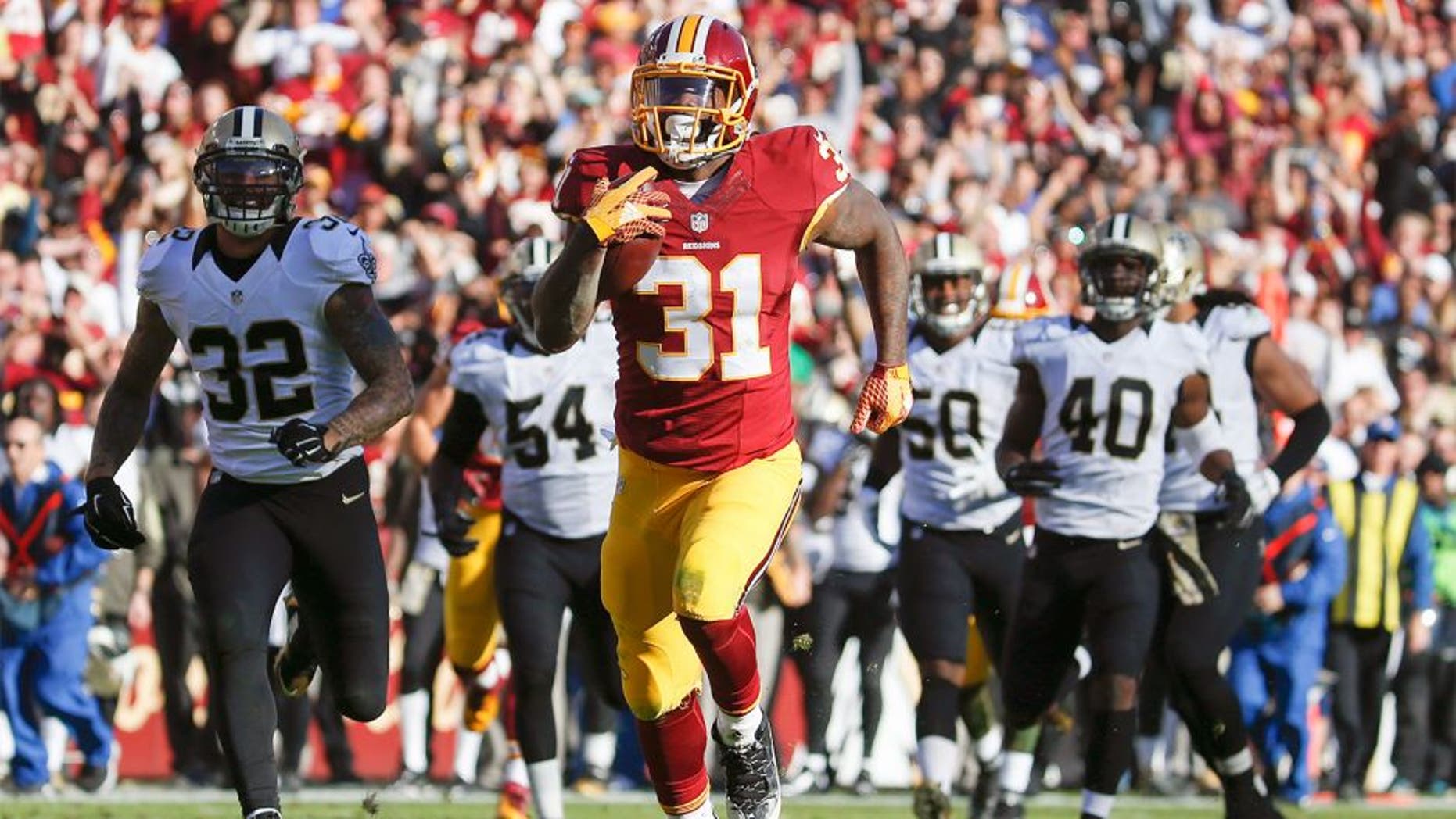 Washington Redskins running back Matt Jones (31) outpaces the New Orleans Saints defense to score a 78 yard touchdown during the first half of an NFL football game in Landover, Md., Sunday, Nov. 15, 2015. (AP Photo/Evan Vucci)