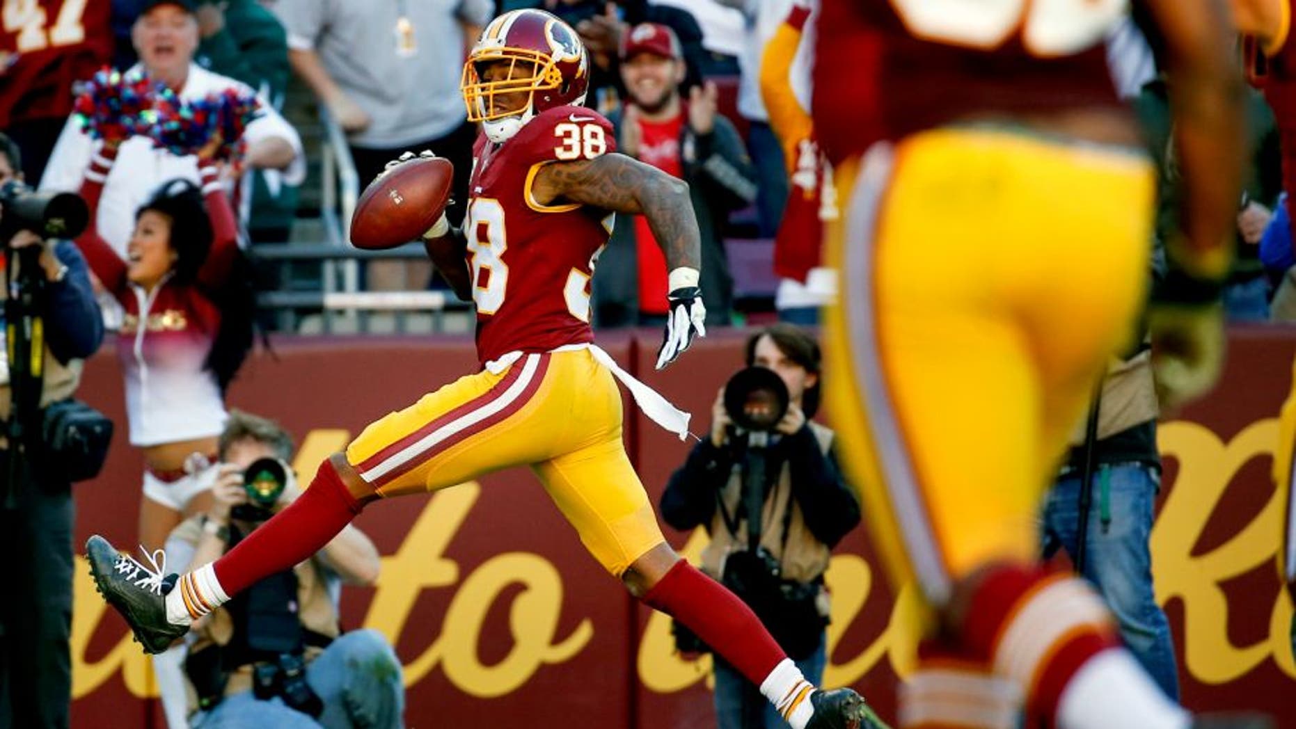 Washington Redskins free safety Dashon Goldson (38) steps into the end zone for a touchdown during the second half of an NFL football game against the New Orleans Saints in Landover, Md., Sunday, Nov. 15, 2015. (AP Photo/Alex Brandon)
