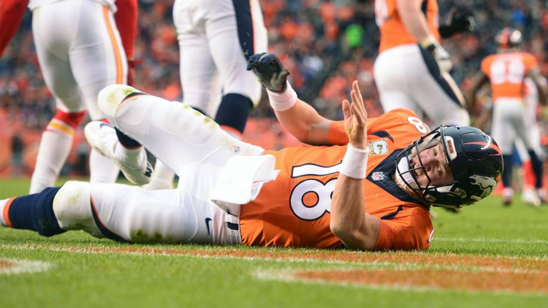 DENVER, CO - NOVEMBER 15: Peyton Manning (18) of the Denver Broncos is knocked down by Justin Houston (50) of the Kansas City Chiefs in the third quarter. The Broncos played the Kansas City Chiefs at Sports Authority Field at Mile High in Denver, CO on November 15, 2015. (Photo by Aaron Ontiveroz/The Denver Post via Getty Images)