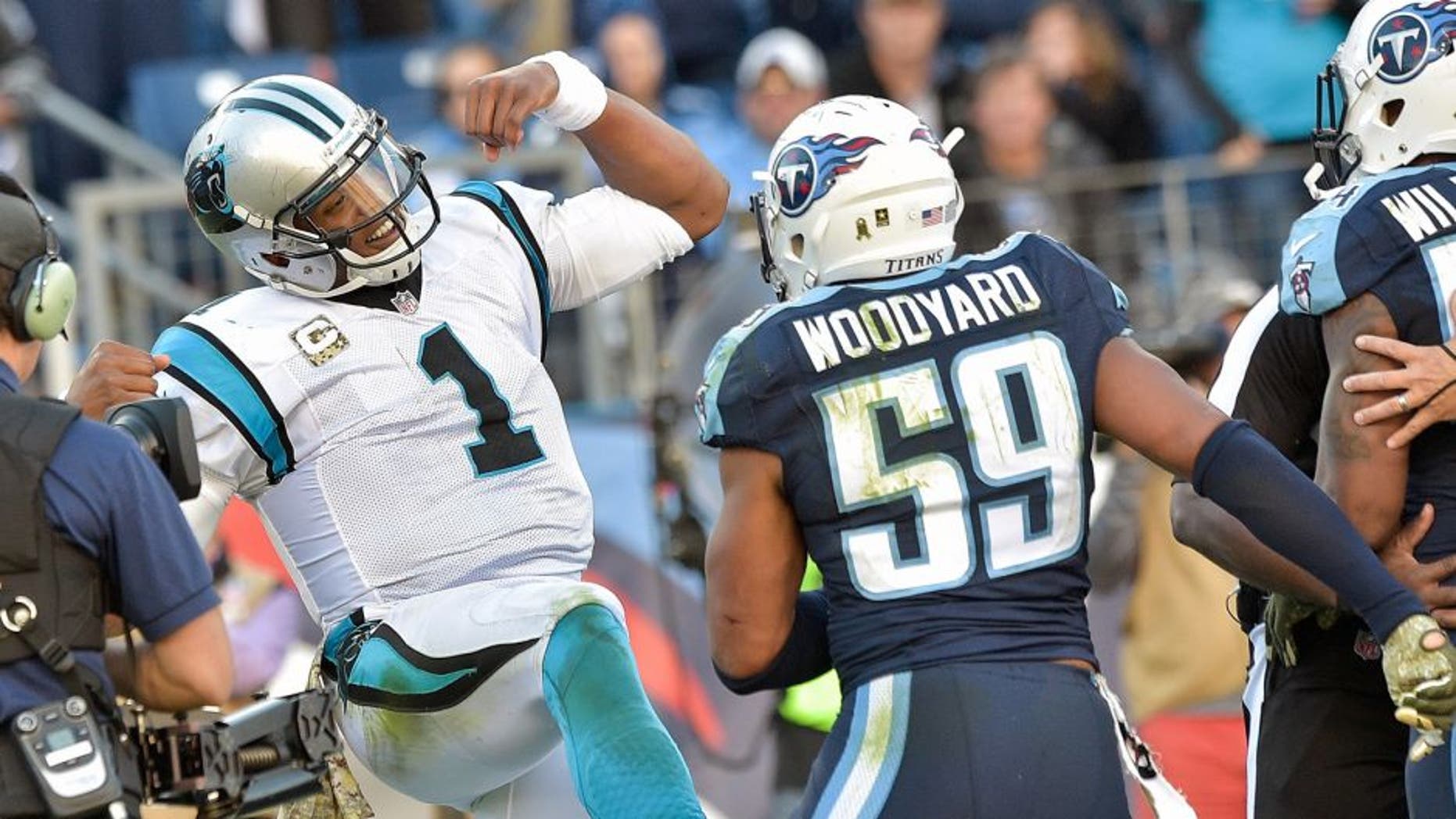 Nov 15, 2015; Nashville, TN, USA; Carolina Panthers quarterback Cam Newton (1) reacts in the end zone toward Tennessee Titans inside linebacker Wesley Woodyard (59) after scoring a touchdown during the second half at Nissan Stadium. Carolina won 27-10. Mandatory Credit: Jim Brown-USA TODAY Sports
