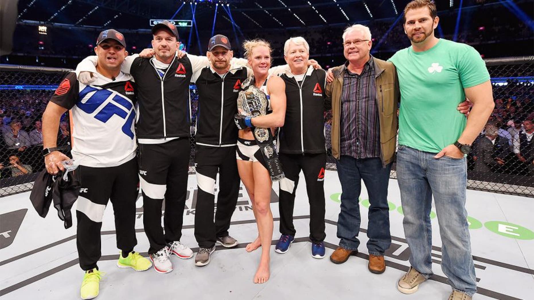 MELBOURNE, AUSTRALIA - NOVEMBER 15: Holly Holm celebrates with Team Holm after her second round KO (head kick and punches) against Ronda Rousey (not pictured) to win their UFC women's bantamweight championship bout during the UFC 193 event at Etihad Stadium on November 15, 2015 in Melbourne, Australia. (Photo by Josh Hedges/Zuffa LLC/Zuffa LLC via Getty Images)
