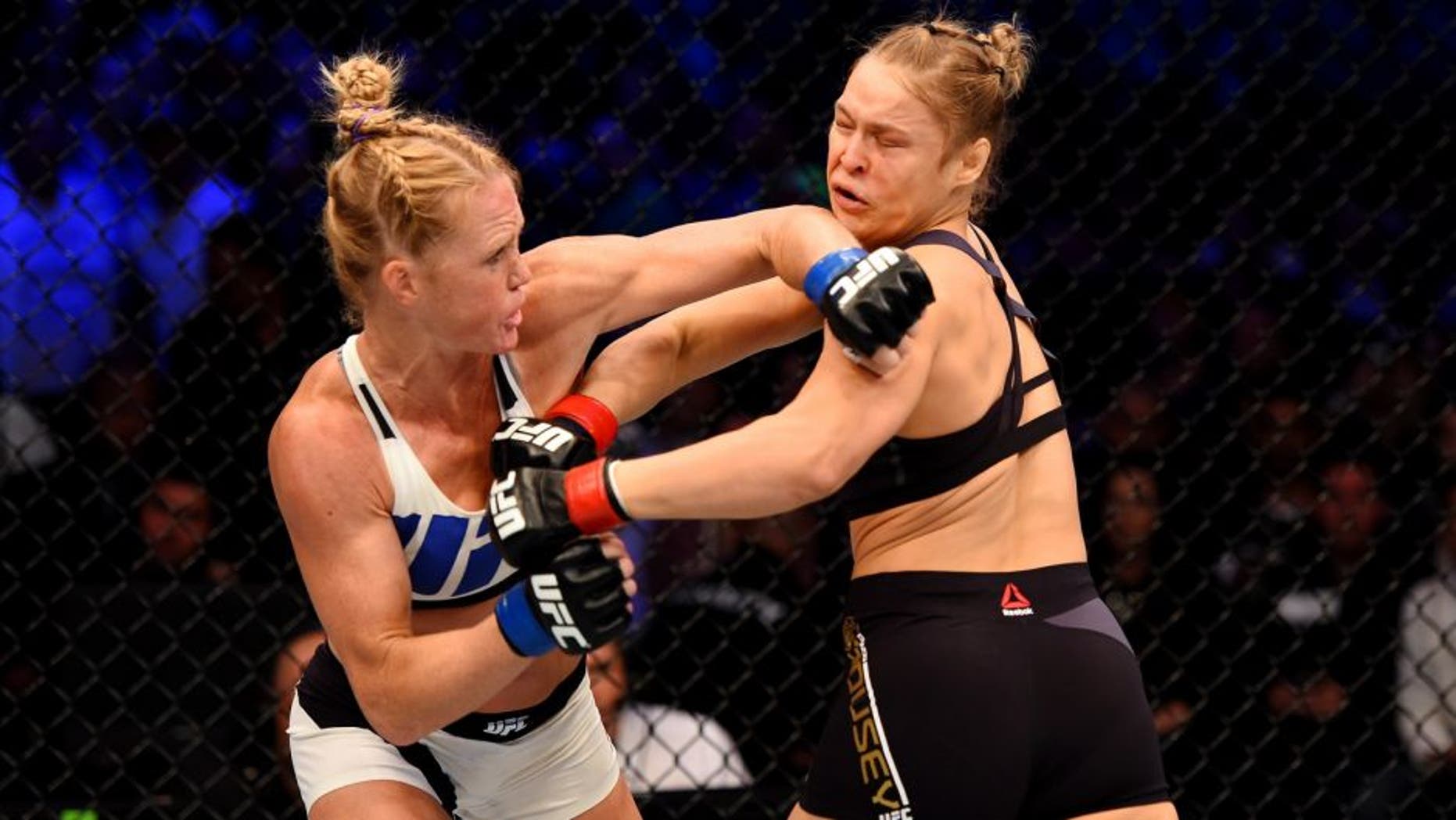 MELBOURNE, AUSTRALIA - NOVEMBER 15: Holly Holm (L) throws a left-handed punch against Ronda Rousey (R) in the first round of their UFC women's bantamweight championship bout during the UFC 193 event at Etihad Stadium on November 15, 2015 in Melbourne, Australia. (Photo by Josh Hedges/Zuffa LLC/Zuffa LLC via Getty Images)